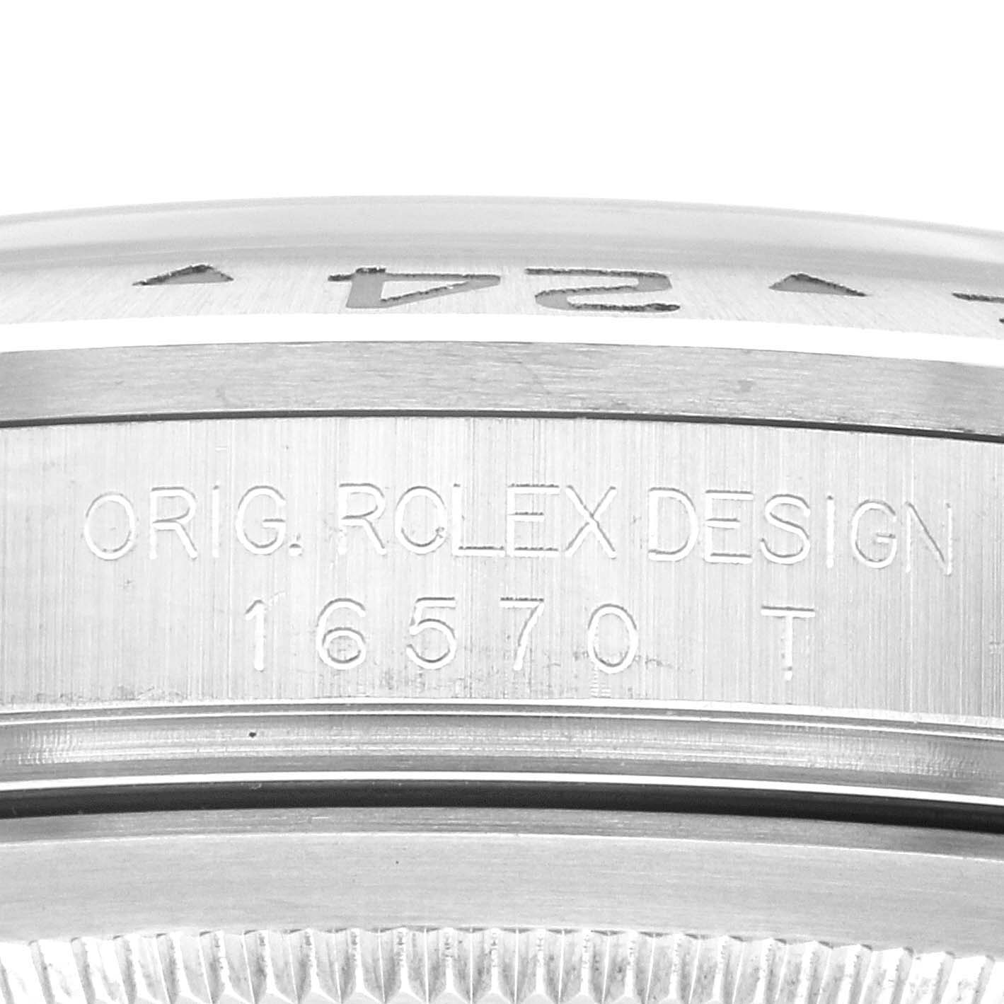 The image shows a close-up of the Rolex Explorer 16570 Men's Stainless Steel White Dial 16570 Men's Stainless Steel White Dial model's side case, revealing the engraving "ORIG. ROLEX DESIGN 16570 T".