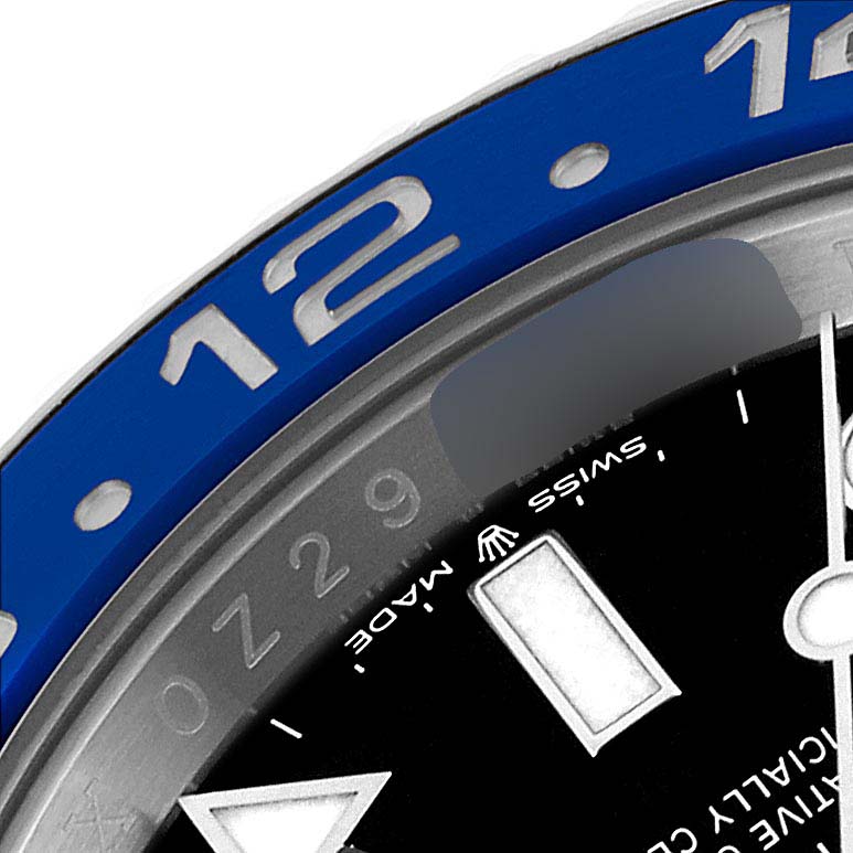 Close-up of a Rolex GMT-Master 126710 Men
s Stainless Steel Black Dial 126710 Men
s Stainless Steel Black Dial showing the blue bezel with the number 12 and part of the watch dial with the "Swiss Made" text.