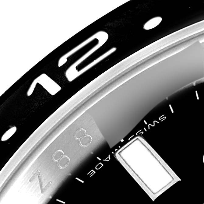 The image shows a close-up of the bezel and a part of the dial on a Rolex GMT-Master 116710 Men
s Stainless Steel Black Dial 116710 Men
s Stainless Steel Black Dial watch.