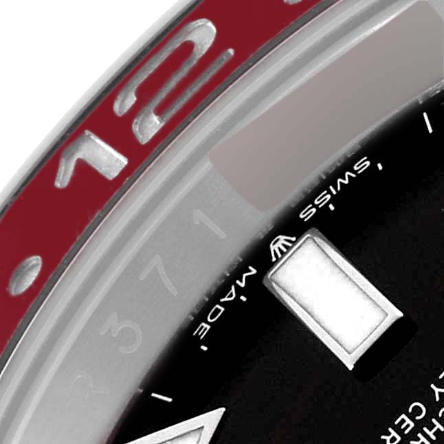 This close-up of the Rolex GMT-Master 126710BLRO Men
s Stainless Steel Black Dial 126710BLRO Men
s Stainless Steel Black Dial watch shows the bezel, part of the dial, and the "Swiss Made" text.