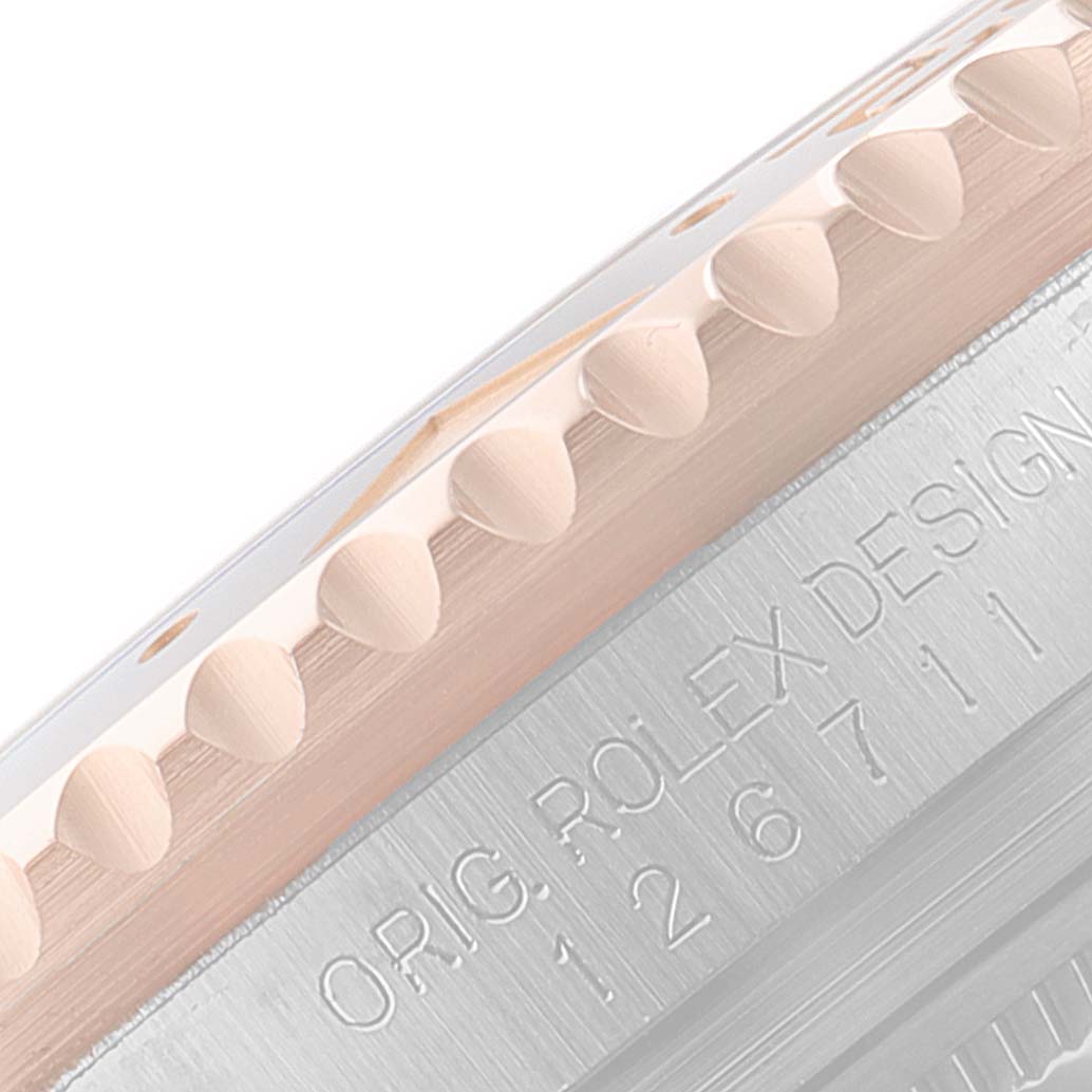 This image shows a close-up angle of the bezel and inner rim of a Rolex GMT-Master 126711CHNR Men's Steel and Gold (two tone) Black Dial 126711CHNR Men's Steel and Gold (two tone) Black Dial watch, highlighting its model number and "Orig. Rolex Design" engraving.