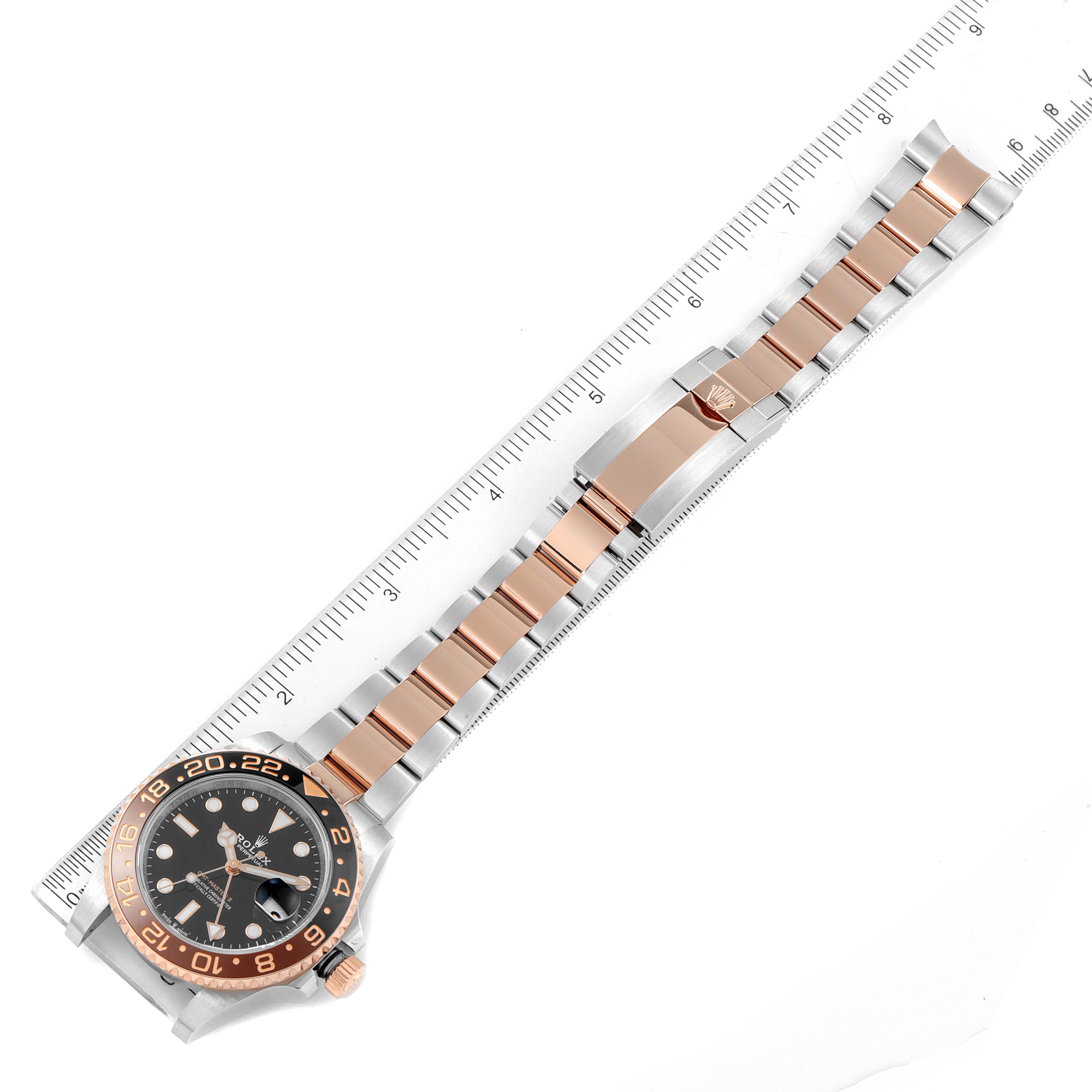 This image shows a top-view angle of the Rolex GMT-Master 126711CHNR Men's Steel and Gold (two tone) Black Dial 126711CHNR Men's Steel and Gold (two tone) Black Dial watch, highlighting the face, bezel, and strap with a ruler for scale.