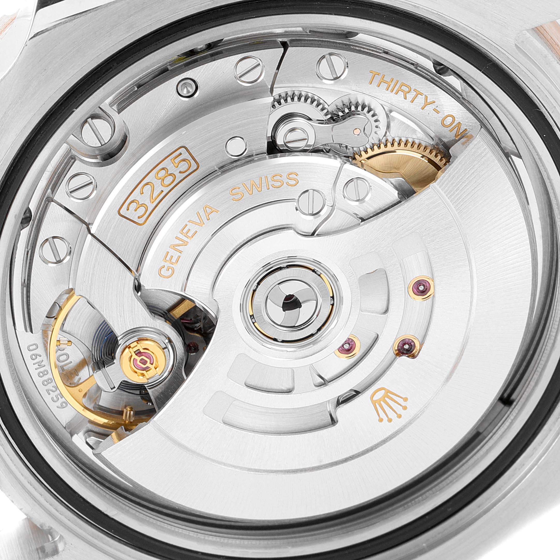 This is a close-up view of the movement and back case of a Rolex GMT-Master 126711CHNR Men's Steel and Gold (two tone) Black Dial 126711CHNR Men's Steel and Gold (two tone) Black Dial watch, showing intricate internal components.