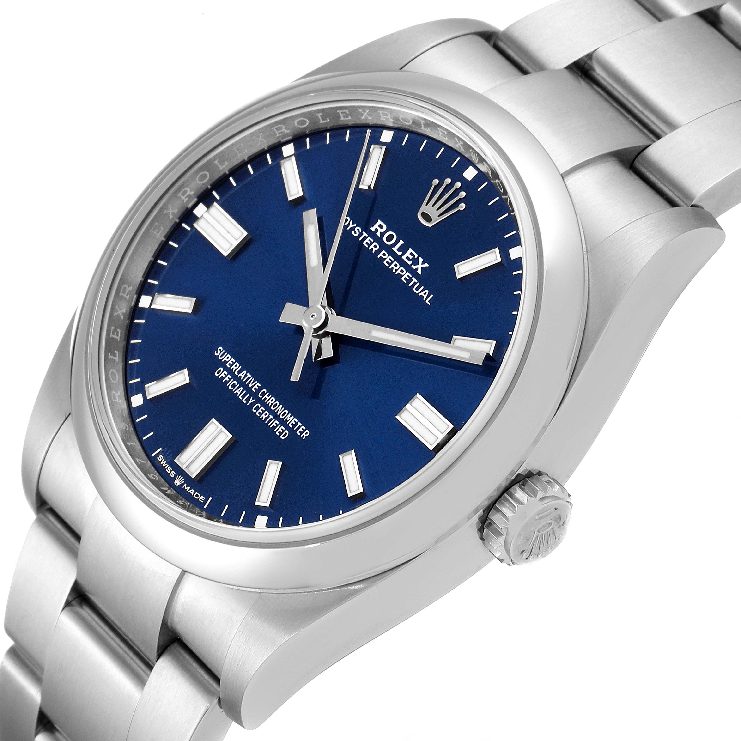 The image shows a Rolex Oyster Perpetual 126000 Men's Stainless Steel Blue Dial 126000 Men's Stainless Steel Blue Dial watch at a slight side angle, displaying the face, crown, and part of the bracelet.