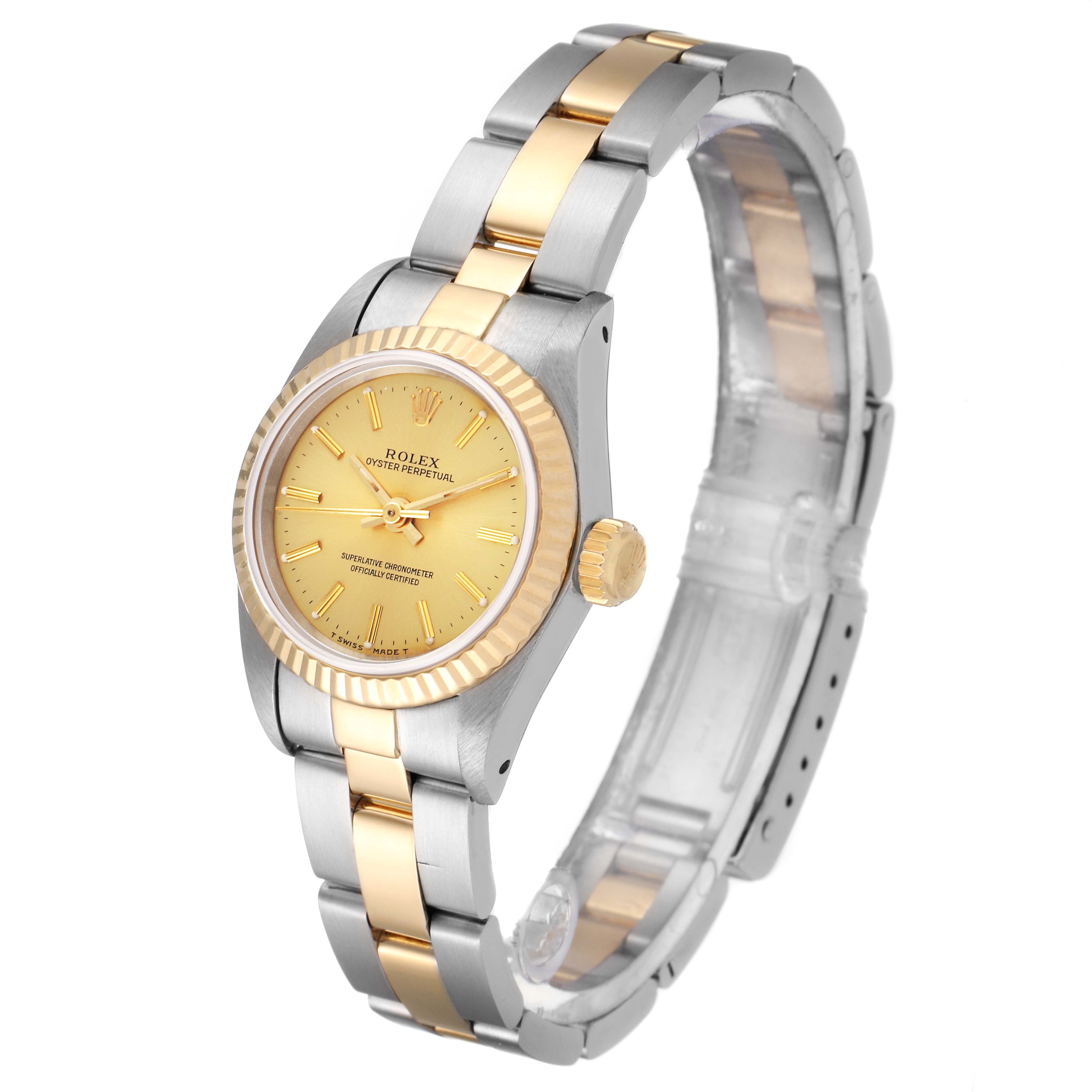 This image shows a Rolex Oyster Perpetual 67193 Women's Steel and Gold (two tone) Champagne Dial 67193 Women's Steel and Gold (two tone) Champagne Dial watch at a slight angle, highlighting its gold dial, bezel, crown, and two-tone metal bracelet.