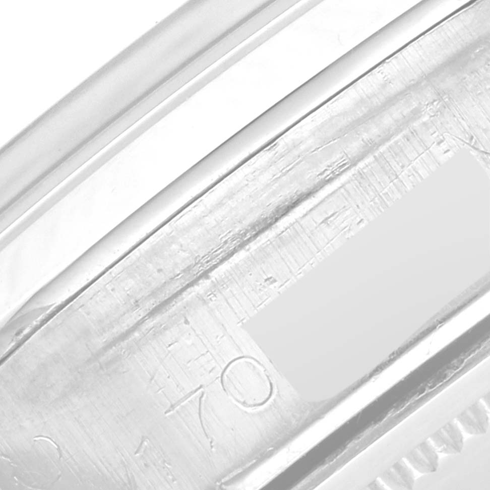 This close-up image shows the engraved serial number on the side of a Rolex Vintage Collection 6694 Men's Stainless Steel Champagne Dial 6694 Men's Stainless Steel Champagne Dial watch case.