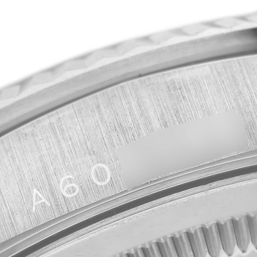 This close-up image shows the engraved serial number on the side of the Rolex President 18239 Men's White Gold Silver Dial 18239 Men's White Gold Silver Dial model watch case.