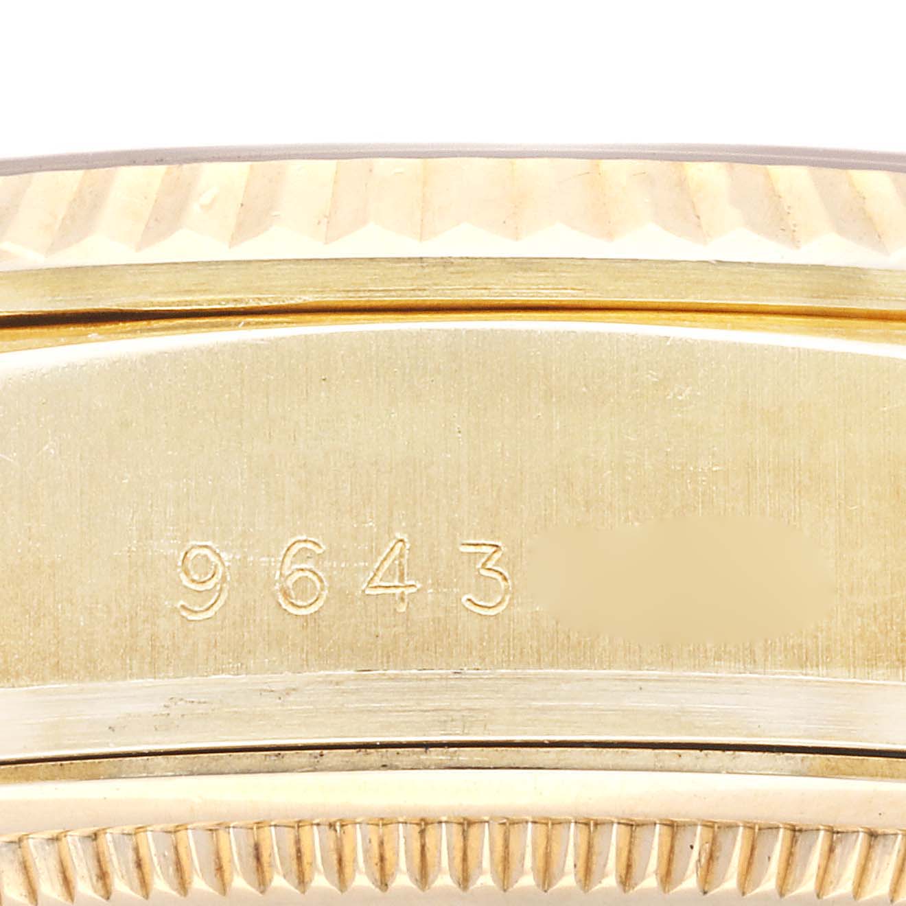 The image shows a close-up of the serial number engraved on the case of a Rolex President 18038 Men's Yellow Gold Champagne Dial 18038 Men's Yellow Gold Champagne Dial model watch.