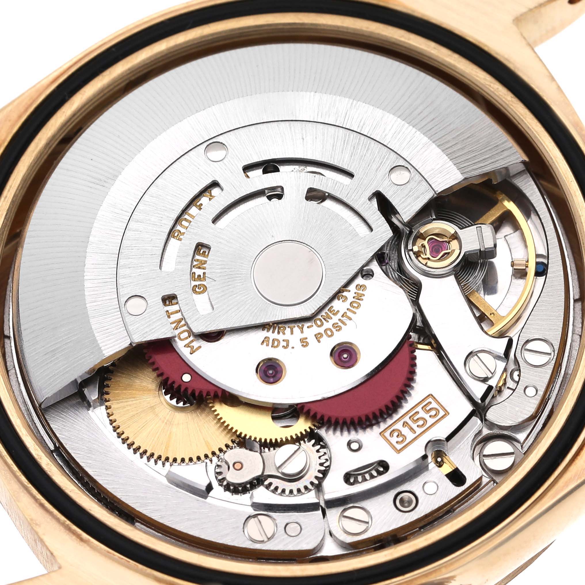 This is an internal view of the Rolex President 18238 Men's Yellow Gold Blue Dial 18238 Men's Yellow Gold Blue Dial model, showcasing its intricate gears and movement parts.