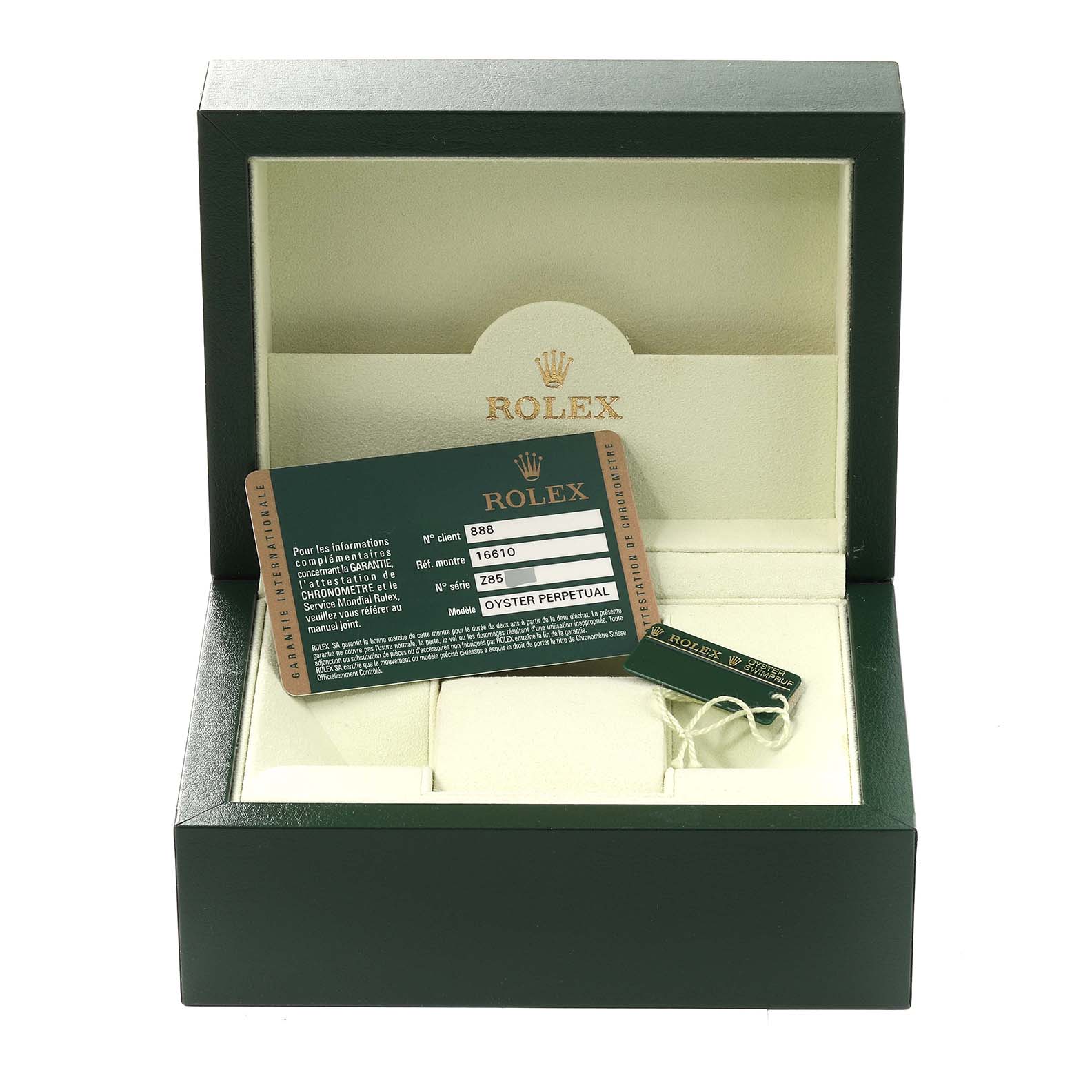 This image shows an open Rolex Submariner 16610 Men
s Stainless Steel Black Dial 16610 Men
s Stainless Steel Black Dial watch box with warranty card and tag inside.