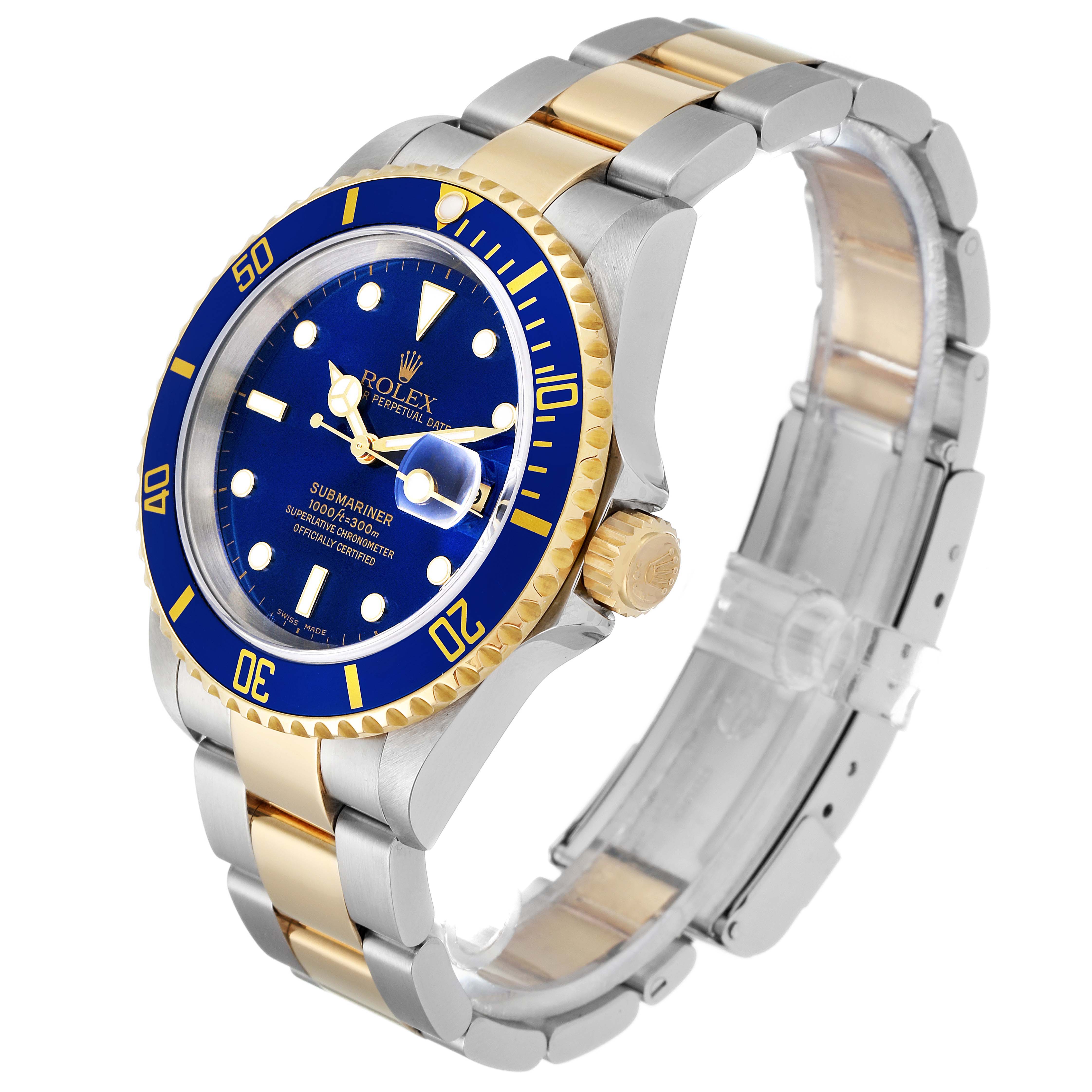 The image shows a Rolex Submariner 16613 Men
s Steel and Gold (two tone) Blue Dial 16613 Men
s Steel and Gold (two tone) Blue Dial watch at a three-quarter angle, highlighting its blue dial, bezel, and two-tone bracelet.
