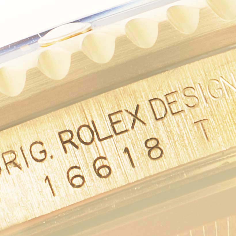 The image shows a close-up of the model number engraving and part of the bezel on a Rolex Submariner 16618 Men's Yellow Gold Grey Dial 16618 Men's Yellow Gold Grey Dial watch.