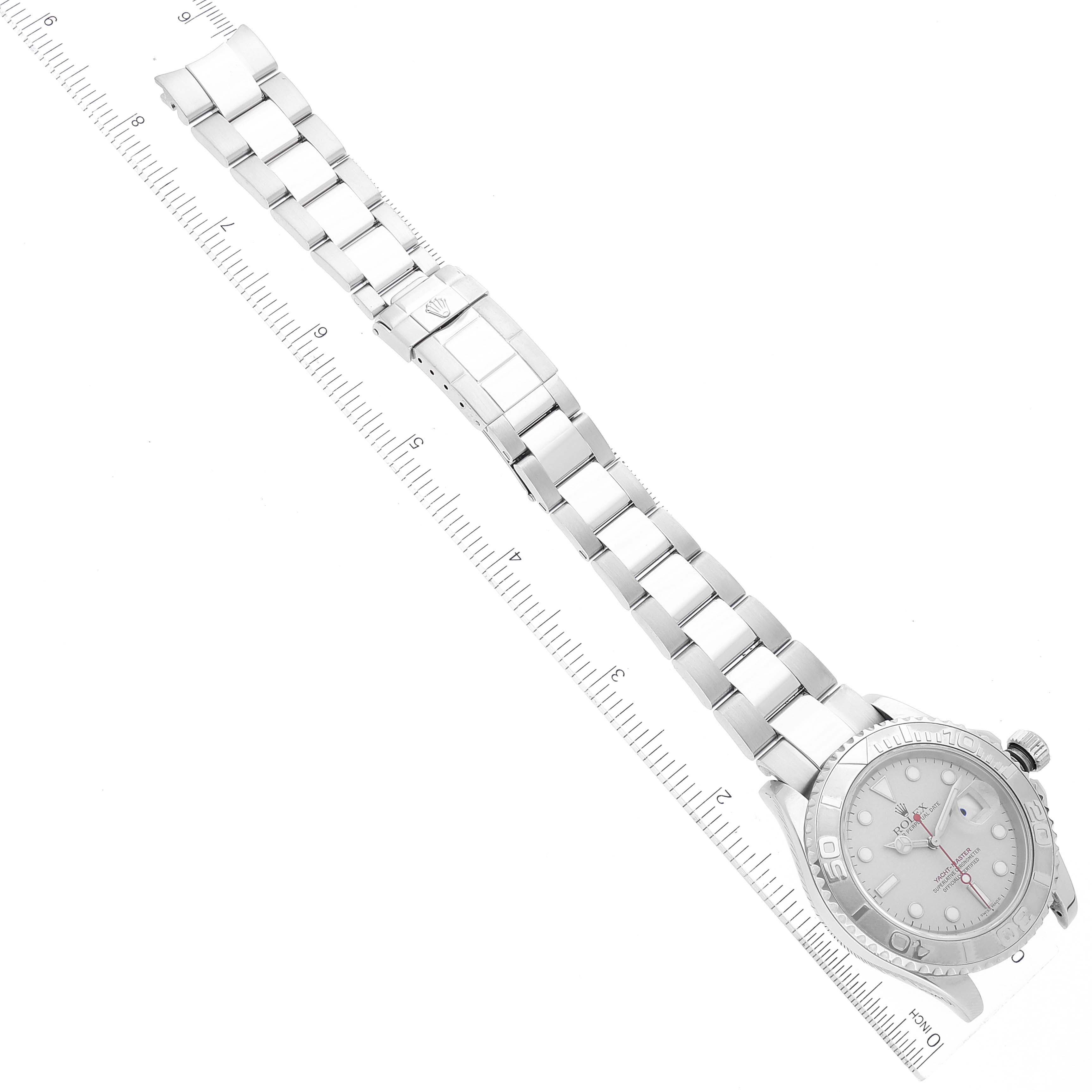 The image shows a top-down view of a Rolex Yacht-Master 16622 Men's Stainless Steel Silver Dial 16622 Men's Stainless Steel Silver Dial watch, including its bracelet and clasp, next to a ruler.