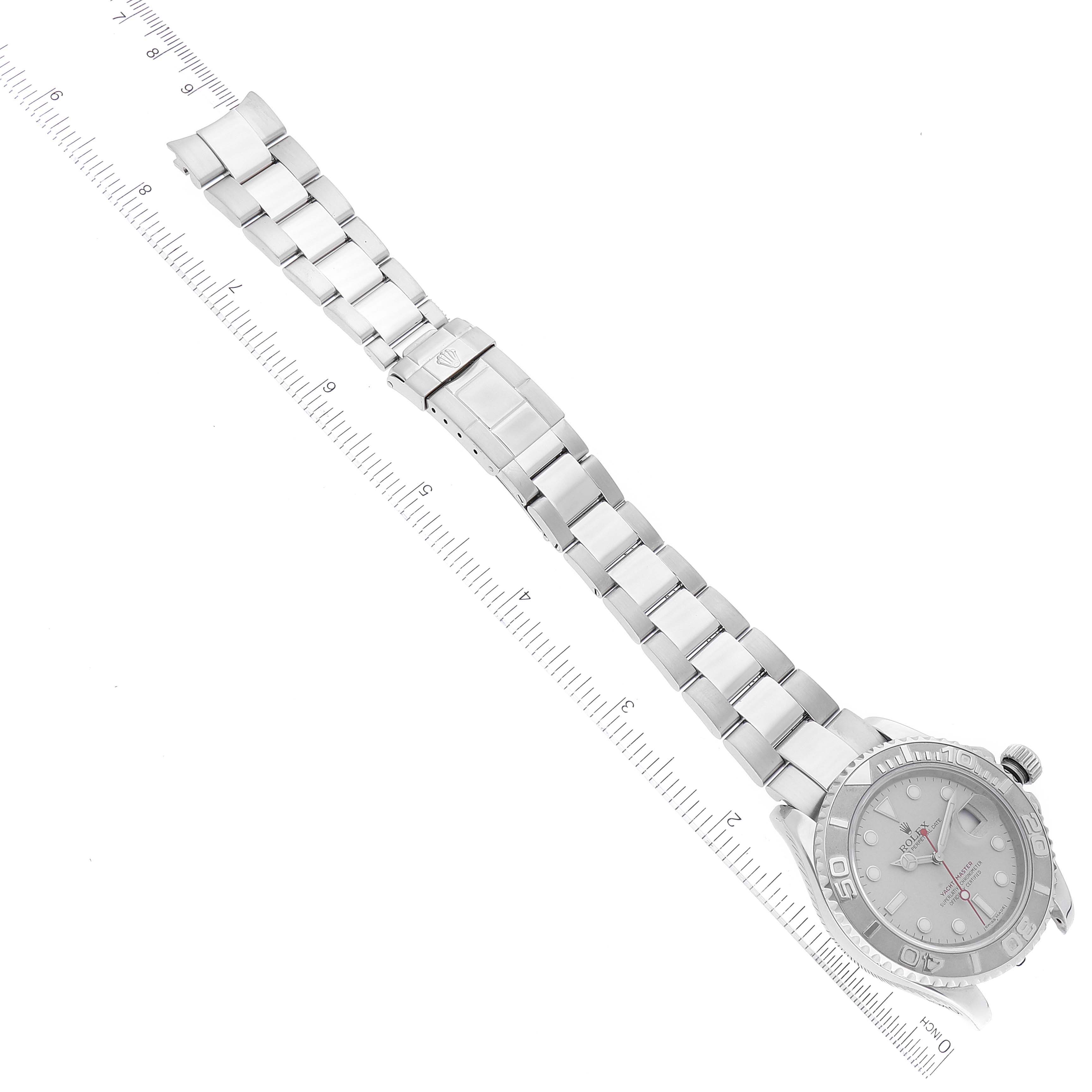 This image shows a Rolex Yacht-Master 16622 Men's Stainless Steel Silver Dial 16622 Men's Stainless Steel Silver Dial watch laid flat with a ruler beside it, displaying the full face and metal bracelet.