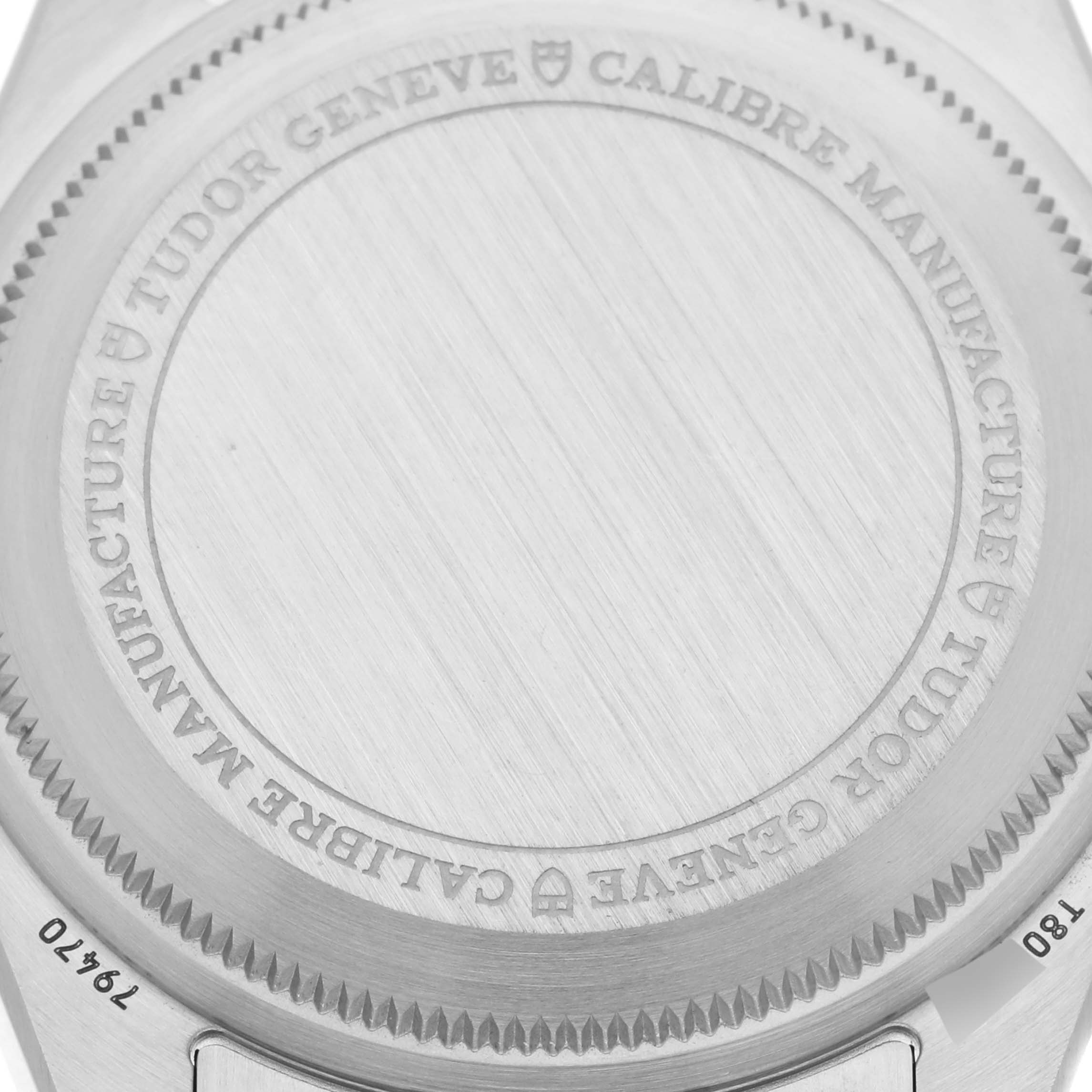 The image shows the case back of a Tudor Heritage Black Bay 79470 Men's Stainless Steel Black Dial 79470 Men's Stainless Steel Black Dial watch from a top-down angle, highlighting the engraving details.