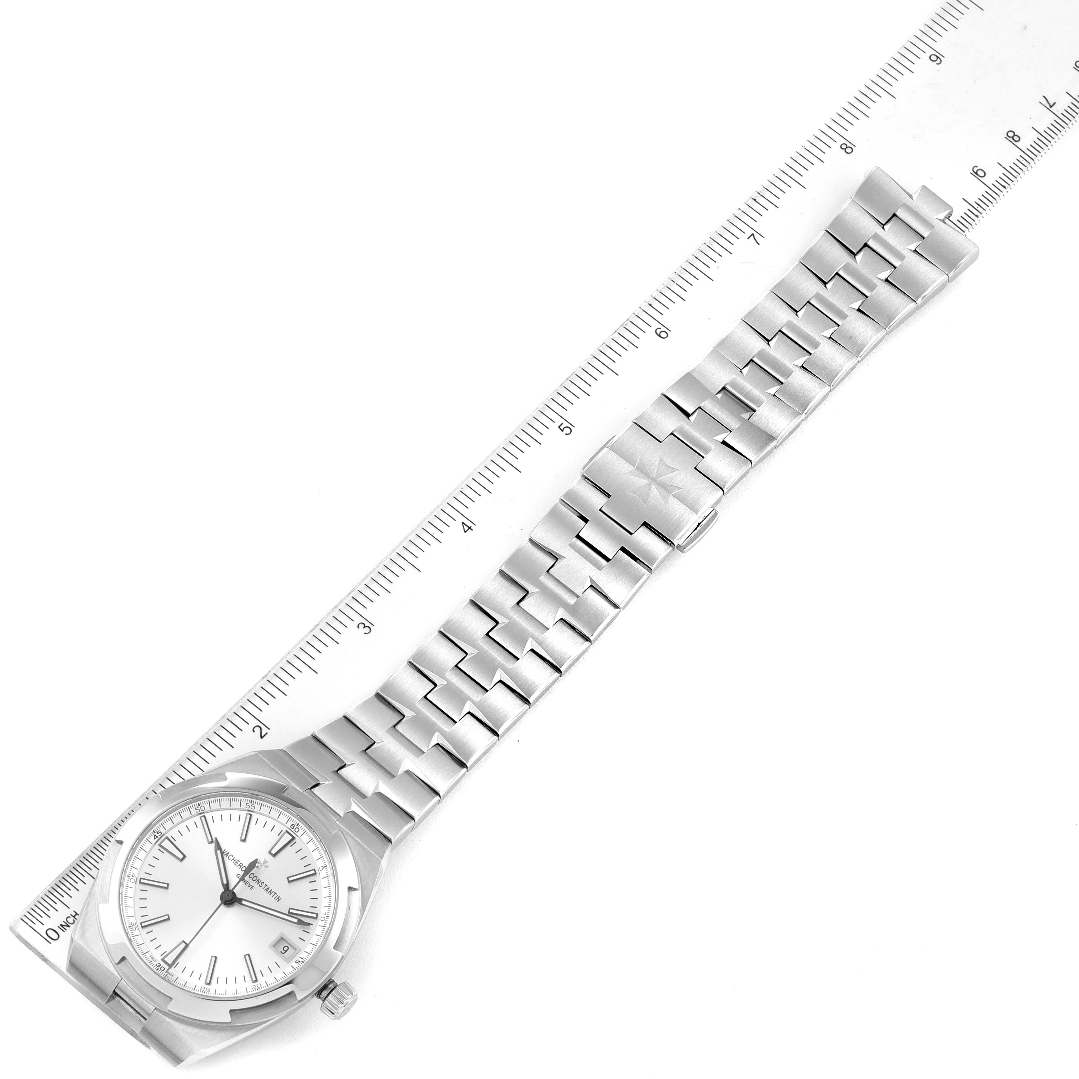 The image shows a Vacheron Constantin Overseas 4500V/110A-B126 Men's Stainless Steel Silver Dial 4500V/110A-B126 Men's Stainless Steel Silver Dial watch from a top-down angle, displaying the full bracelet and face alongside a ruler.