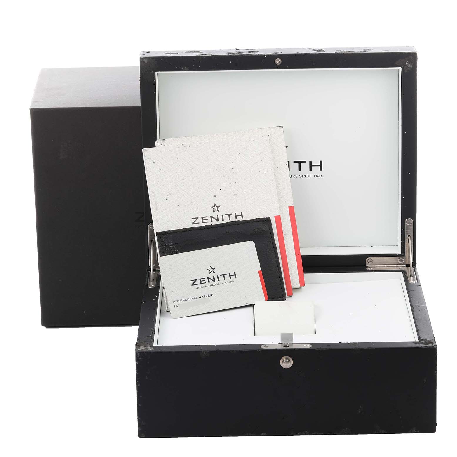 The image shows the open box and documentation for a Zenith Defy 95.9000.670 Men
s Stainless Steel Grey Dial 95.9000.670 Men
s Stainless Steel Grey Dial watch, including instruction manuals and warranty cards.