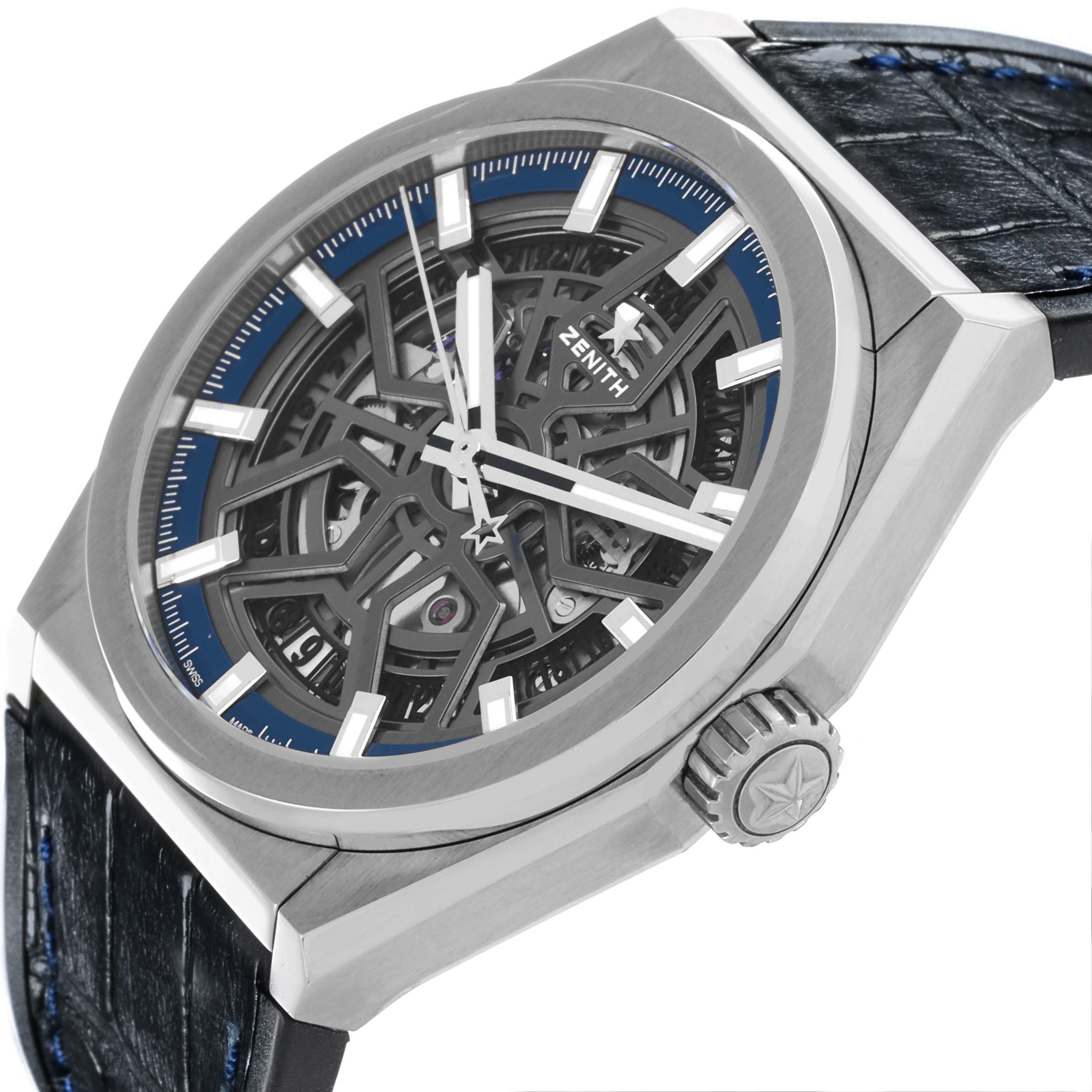 The Zenith Defy 95.9000.670 Men
s Stainless Steel Grey Dial 95.9000.670 Men
s Stainless Steel Grey Dial watch is shown at an angled view, highlighting the skeleton dial, bezel, and crown with a leather strap.