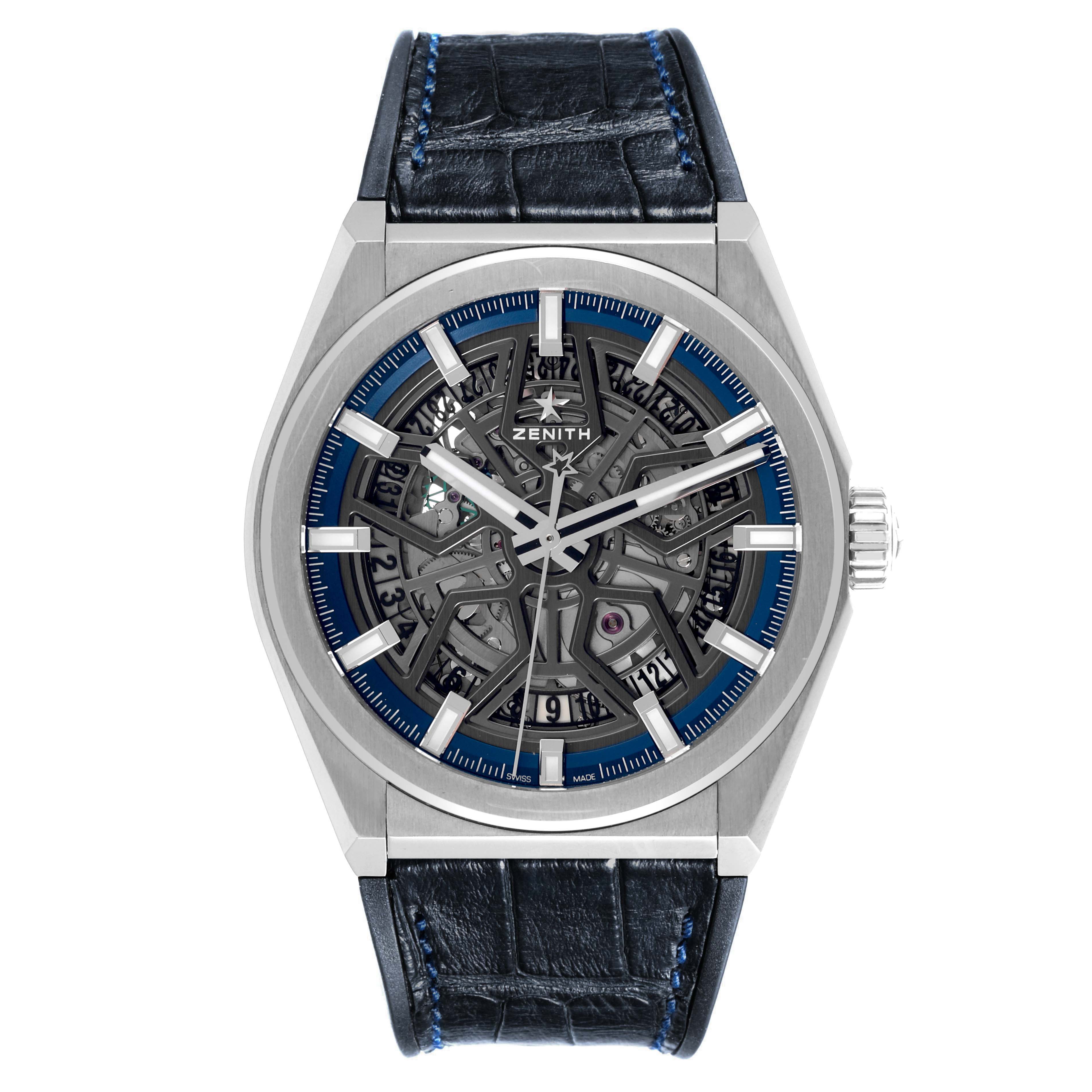 The Zenith Defy 95.9000.670 Men
s Stainless Steel Grey Dial 95.9000.670 Men
s Stainless Steel Grey Dial watch is shown from a front angle, displaying its skeleton dial, hour markers, and leather strap.
