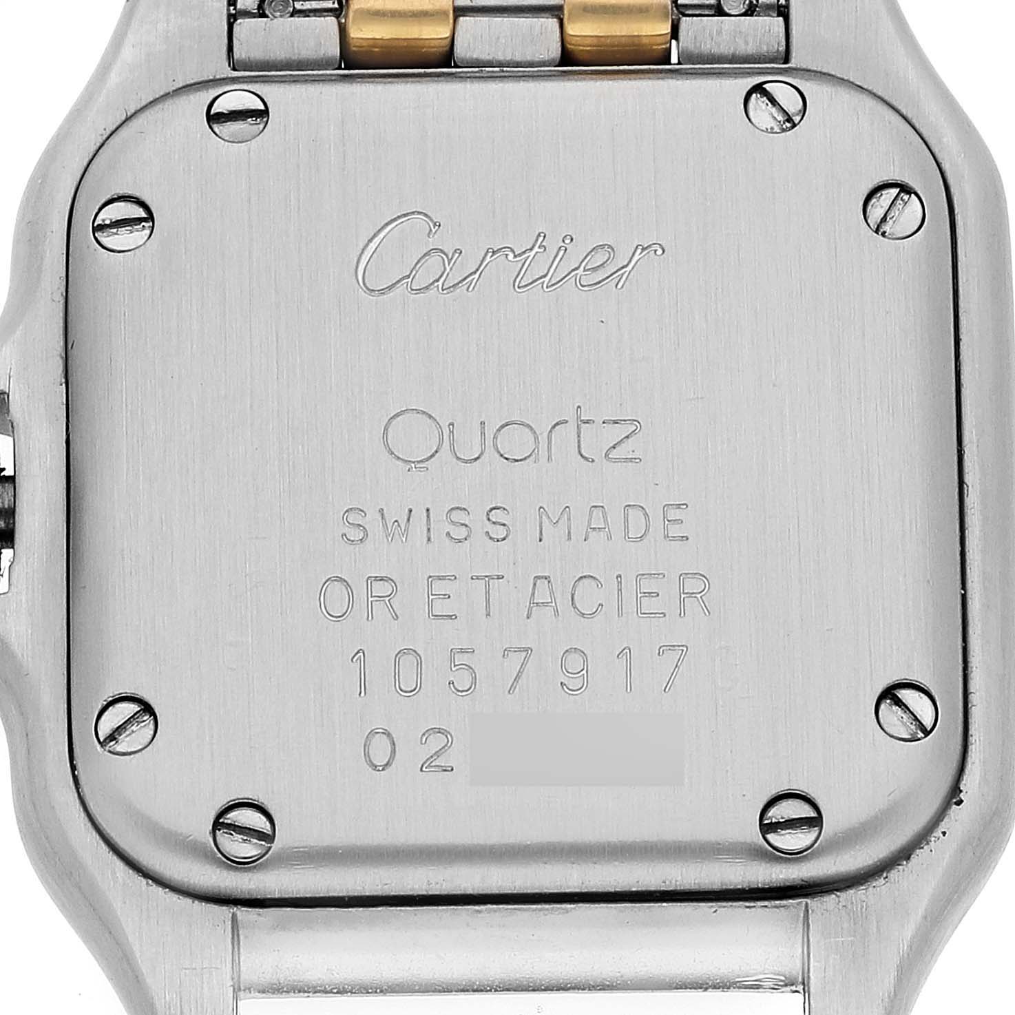 The image shows the back case of a Cartier Panthere W25029B6 Women's Steel and Gold (two tone) Silver Dial W25029B6 Women's Steel and Gold (two tone) Silver Dial watch, displaying inscriptions and screws.