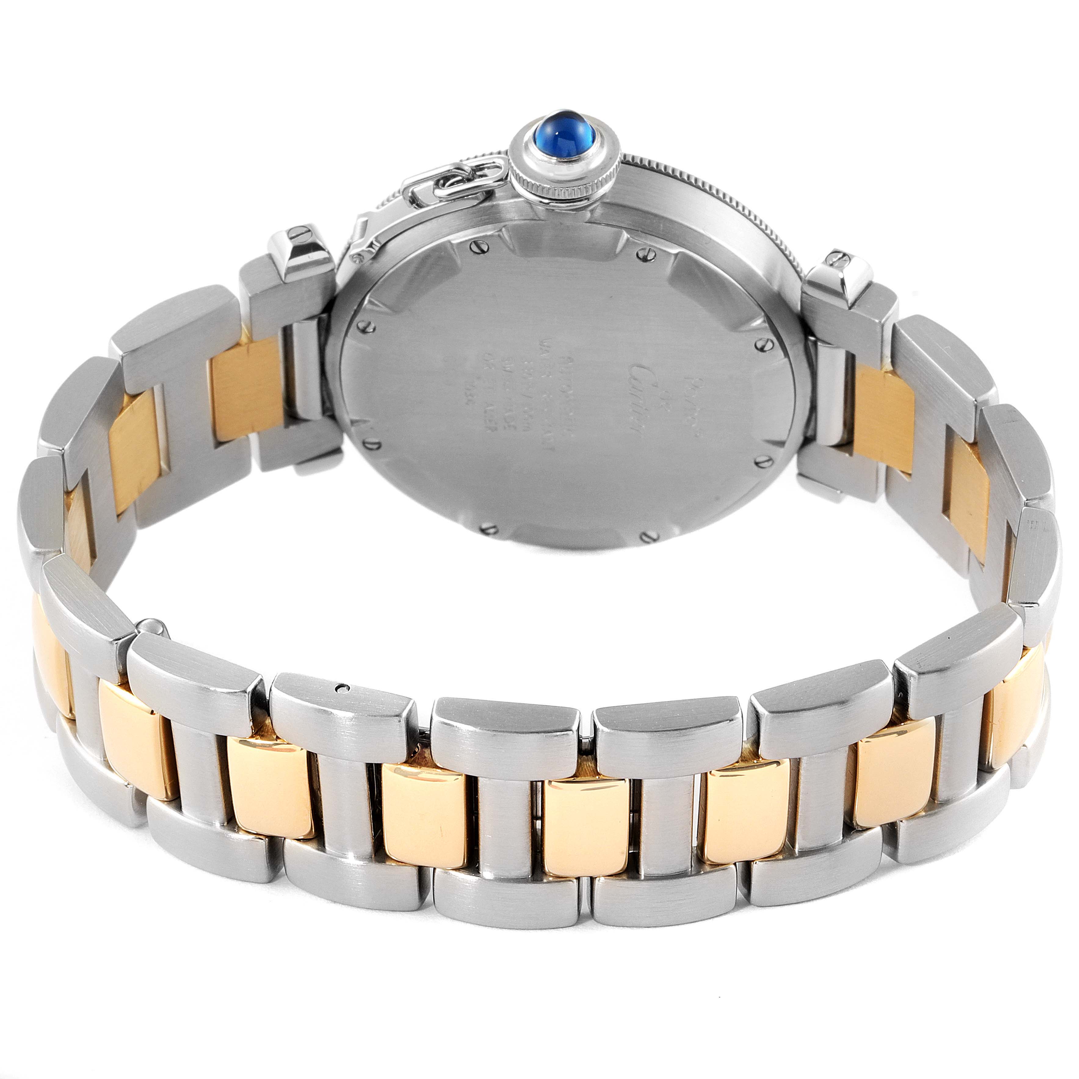 The image shows the back case and bracelet of a Cartier Pasha W31016N1 Men
s Steel and Gold (two tone) Grey Dial W31016N1 Men
s Steel and Gold (two tone) Grey Dial watch, highlighting its two-tone metal links and blue cabochon crown.