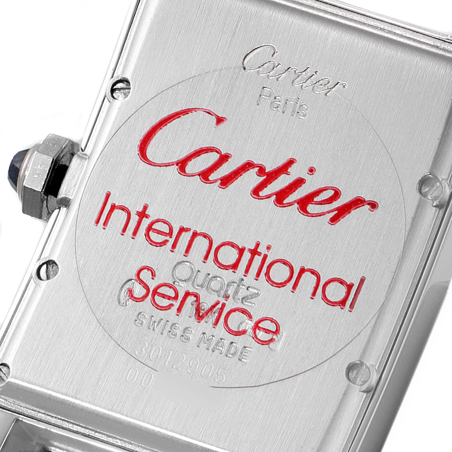 The image shows the back case of a Cartier Tank Américaine watch, highlighting the brand and model details.