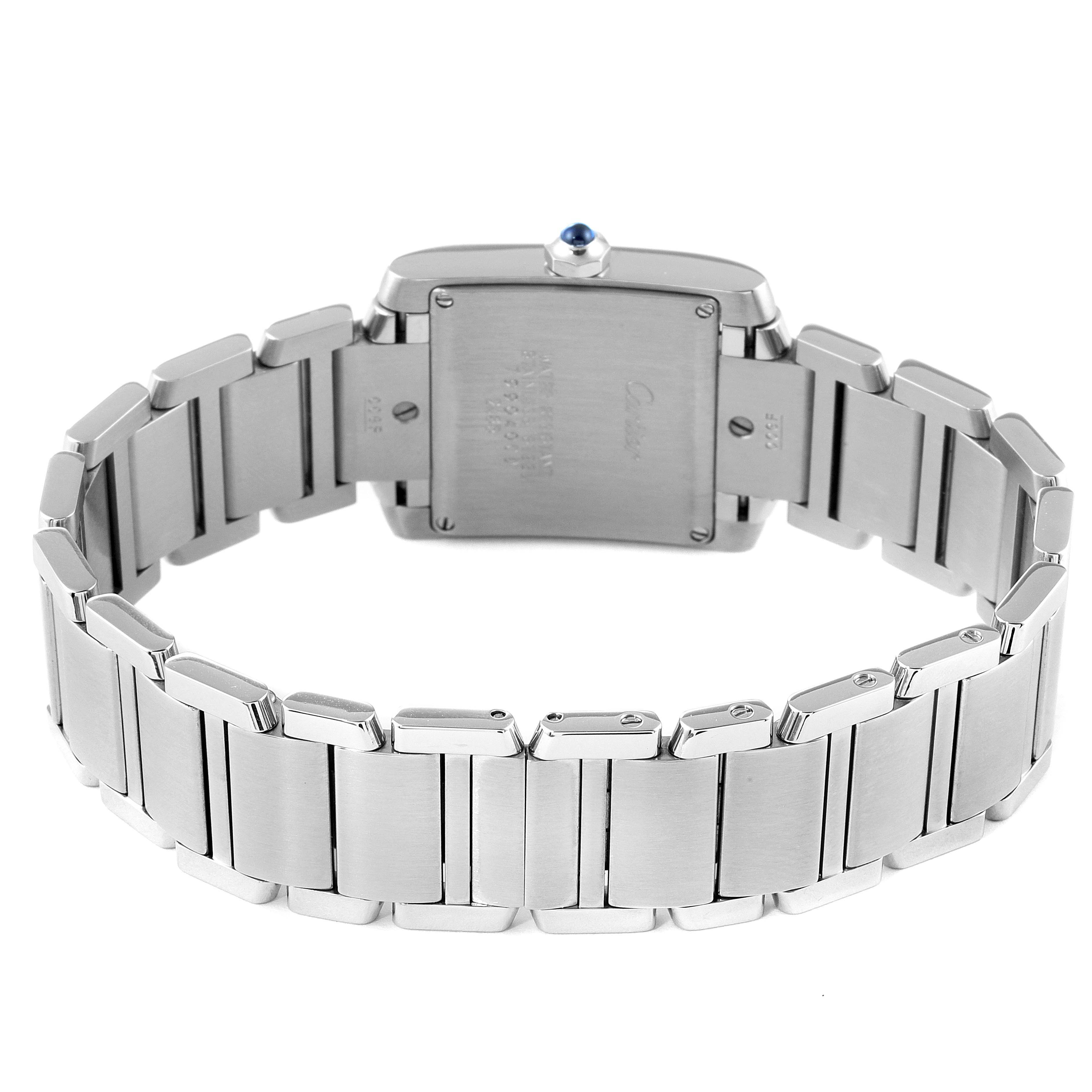 The image shows the back view of the Cartier Tank Française watch, focusing on its stainless steel bracelet and case back.