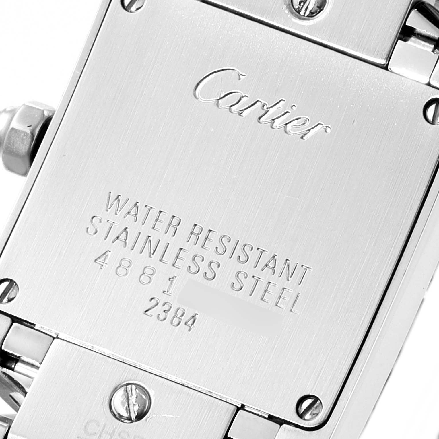 The image shows the back case of a Cartier Tank Française watch, displaying engravings about water resistance and the model number.