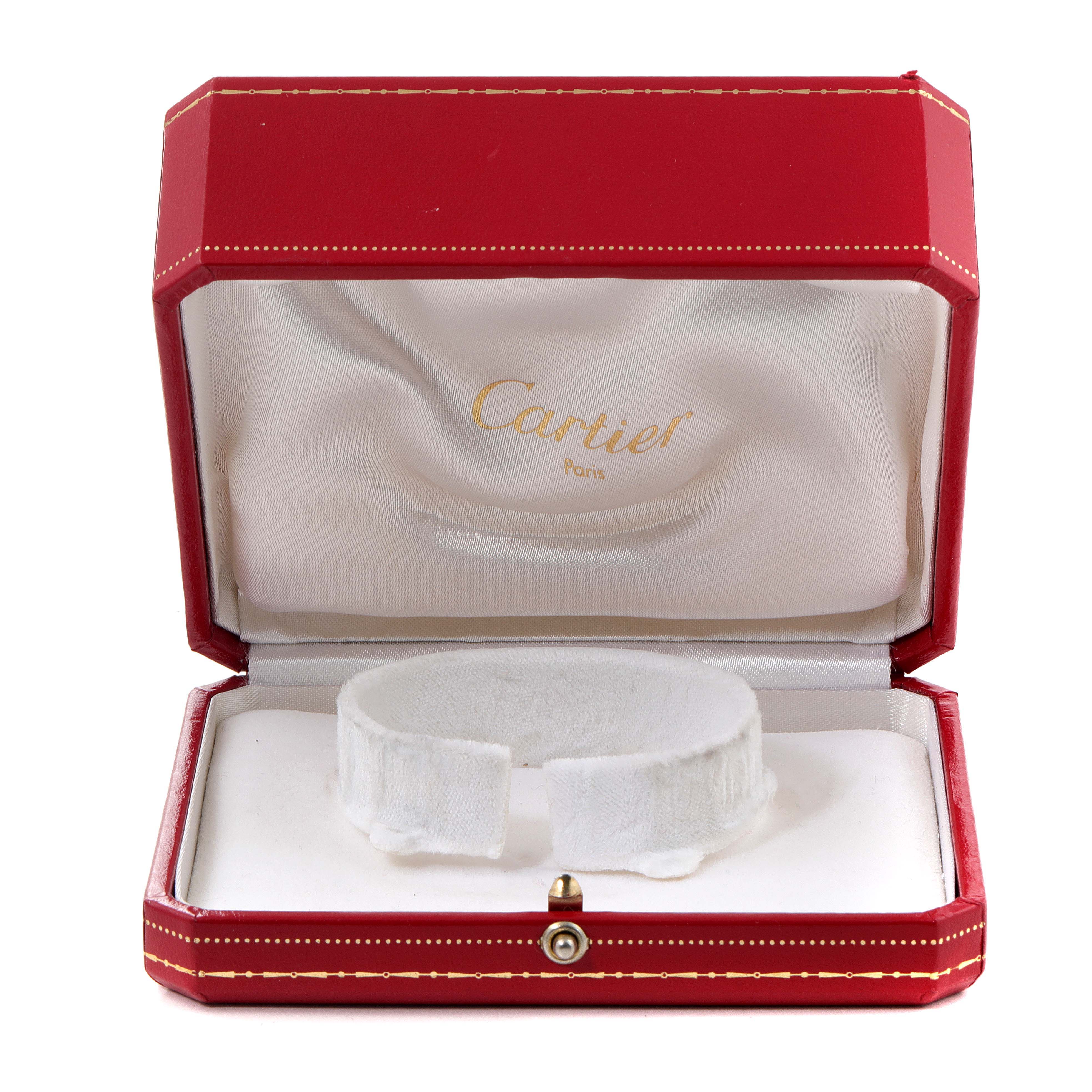 This image shows an open red Cartier case with a padded insert for the Tank Francaise model watch.
