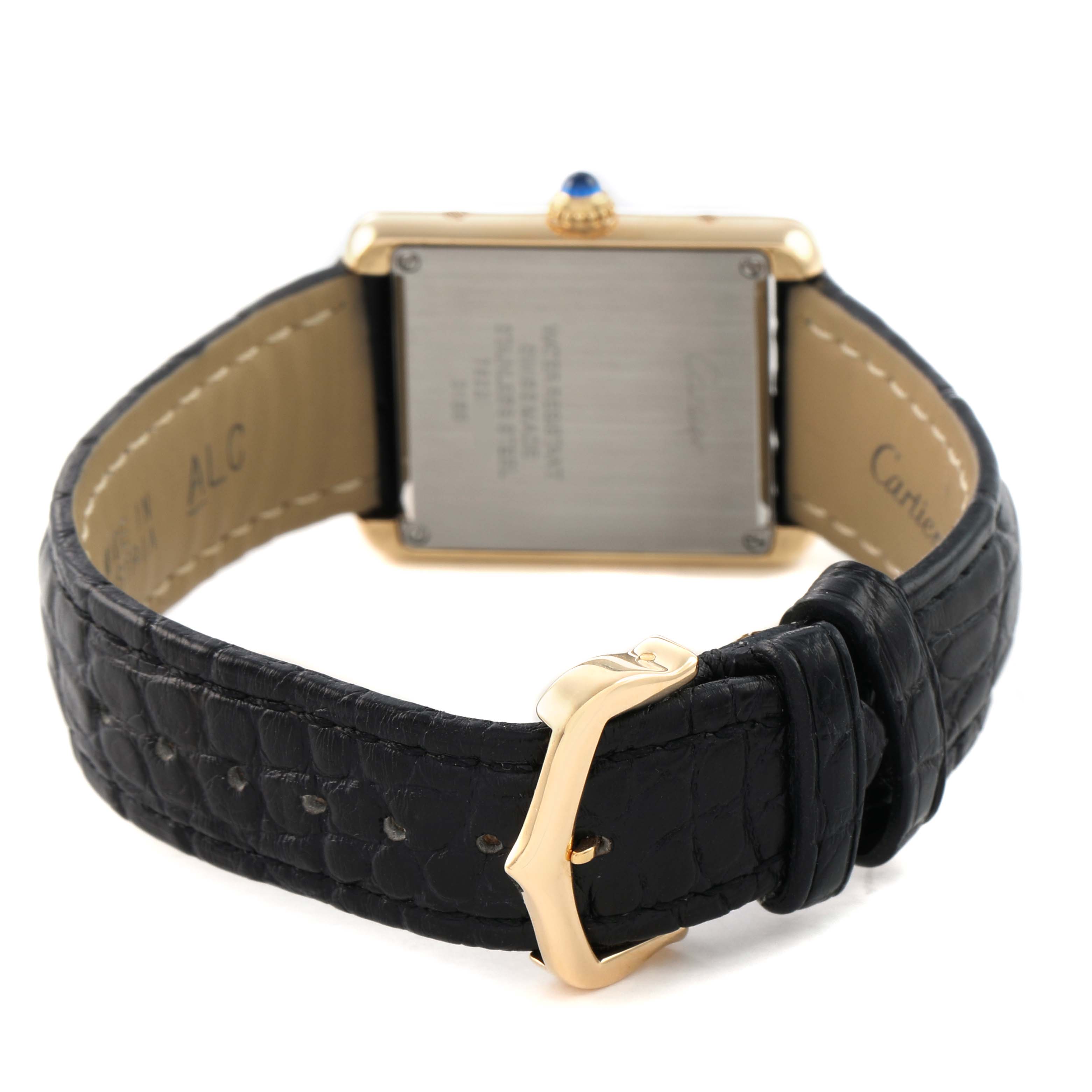 The Cartier Tank Solo W5200002 Women's Yellow Gold Silver Dial watch is shown from the back, displaying the case, crown, and black leather strap with a gold buckle.