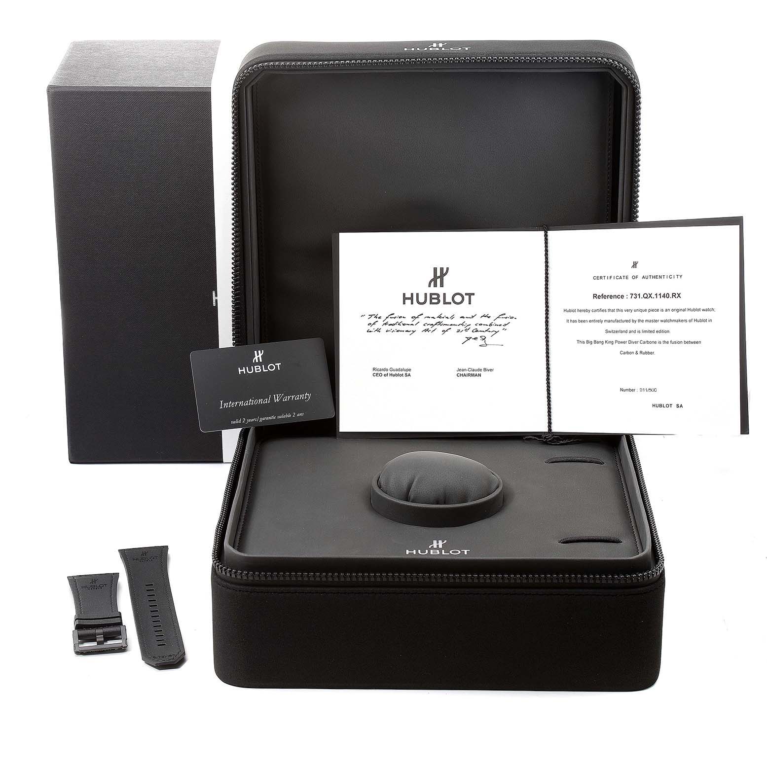 The image shows a Hublot Big Bang 731.QX.1140.RX Men's Titanium Black Dial 731.QX.1140.RX Men's Titanium Black Dial model's accessories including a box, international warranty card, documents, and a strap.