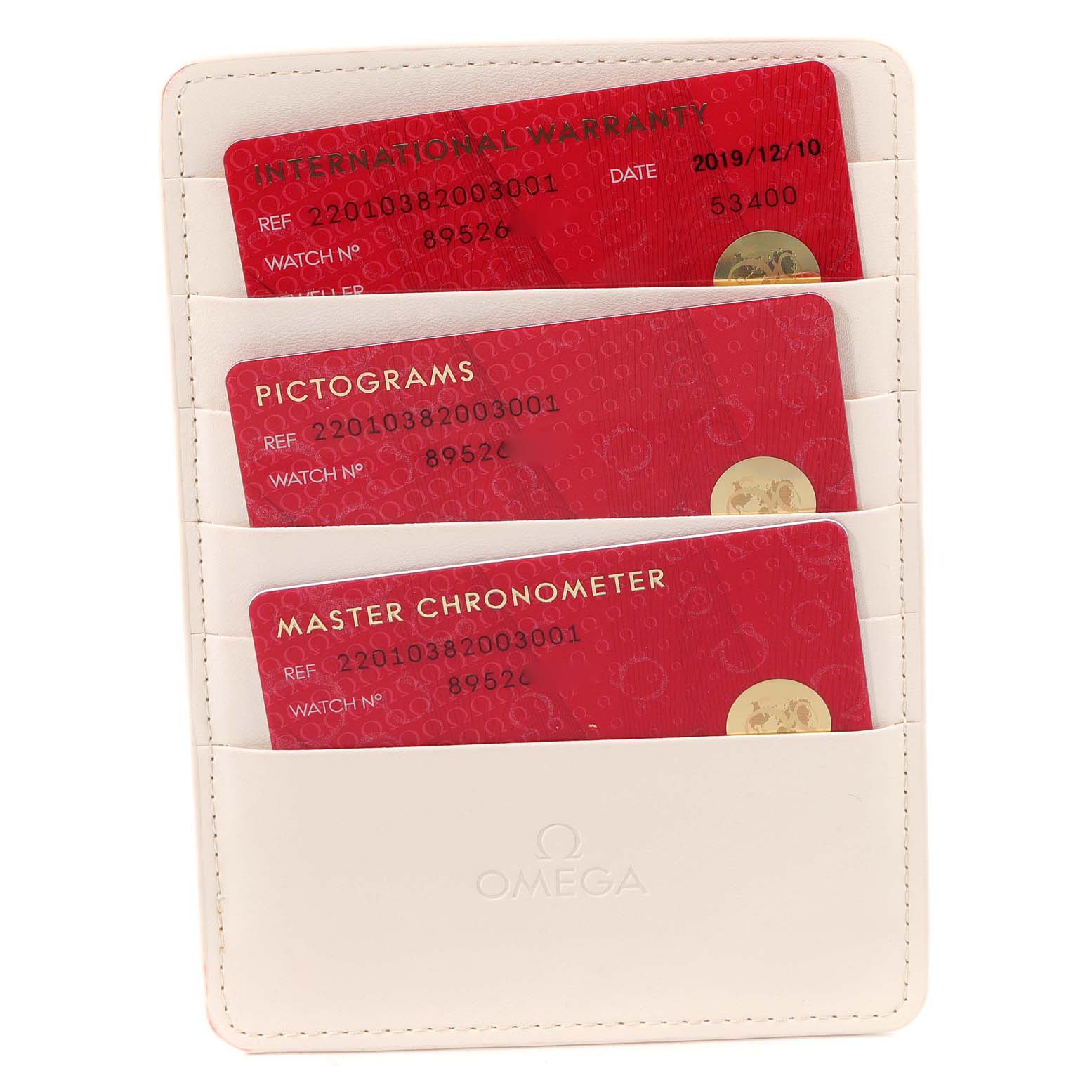 The image shows an Omega Aqua Terra 220.10.38.20.03.001 Men
s Stainless Steel Blue Dial 220.10.38.20.03.001 Men
s Stainless Steel Blue Dial warranty card holder with three red cards: International Warranty, Pictograms, and Master Chronometer.