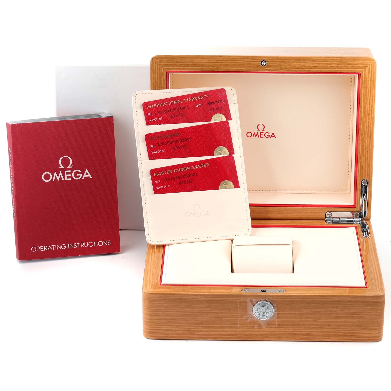 The image shows the packaging, red operating instructions book, warranty cards, and accessories for the Omega Aqua Terra 220.10.38.20.03.001 Men
s Stainless Steel Blue Dial 220.10.38.20.03.001 Men
s Stainless Steel Blue Dial watch model.