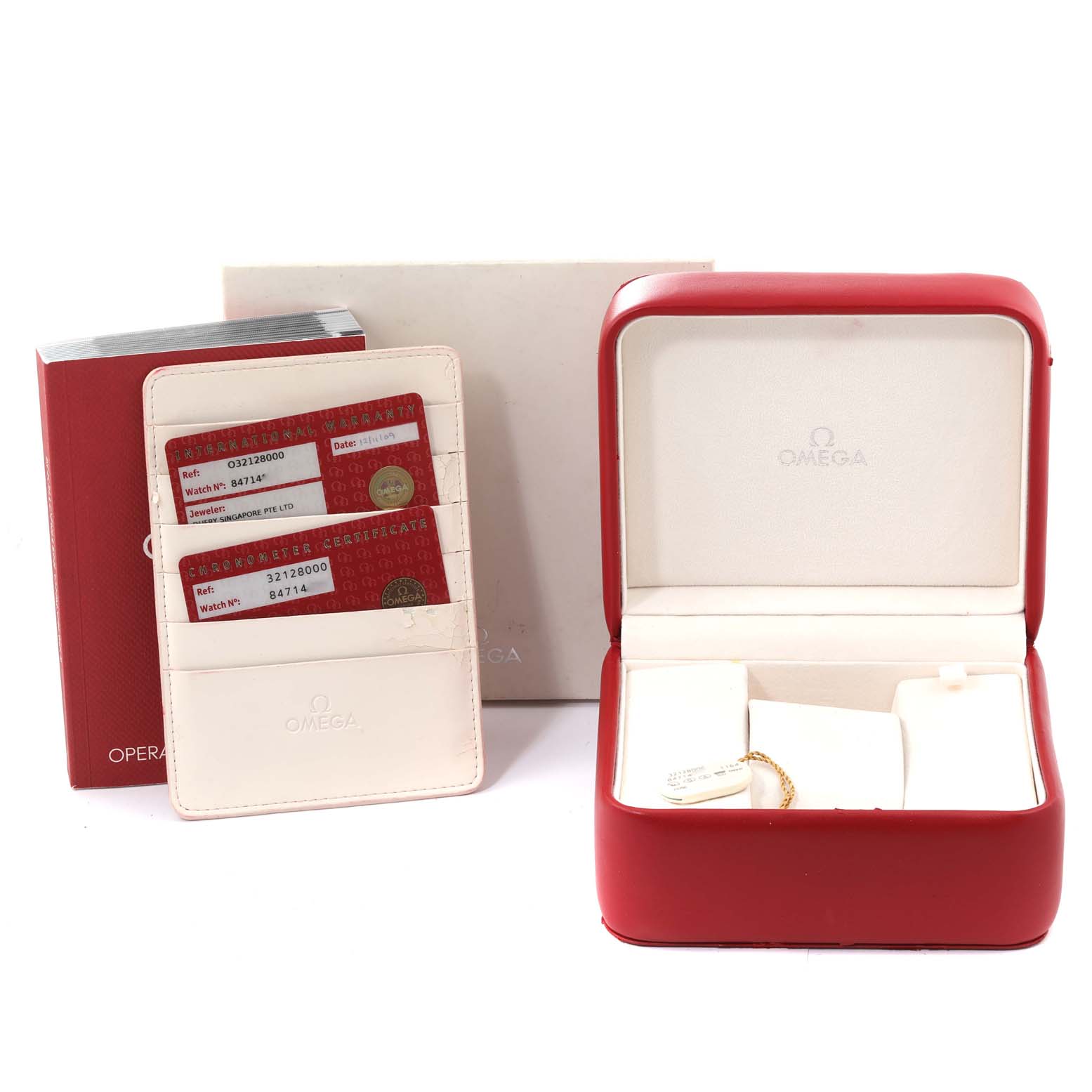 The image shows the packaging and accessories of an Omega Speedmaster 3212.80.00 Men's Stainless Steel Blue Dial 3212.80.00 Men's Stainless Steel Blue Dial, including an open watch box, warranty cards, and an instruction booklet.