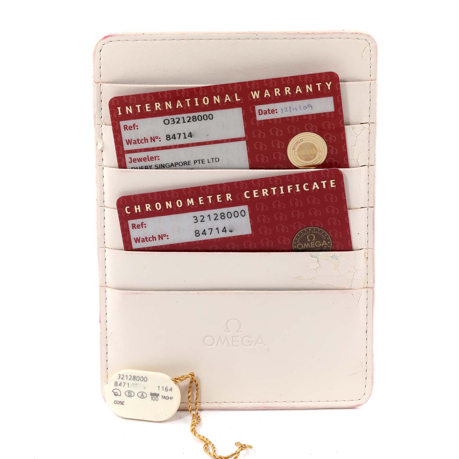 The image shows an Omega Speedmaster 3212.80.00 Men's Stainless Steel Blue Dial 3212.80.00 Men's Stainless Steel Blue Dial's International Warranty and Chronometer Certificate cards in a white Omega holder.