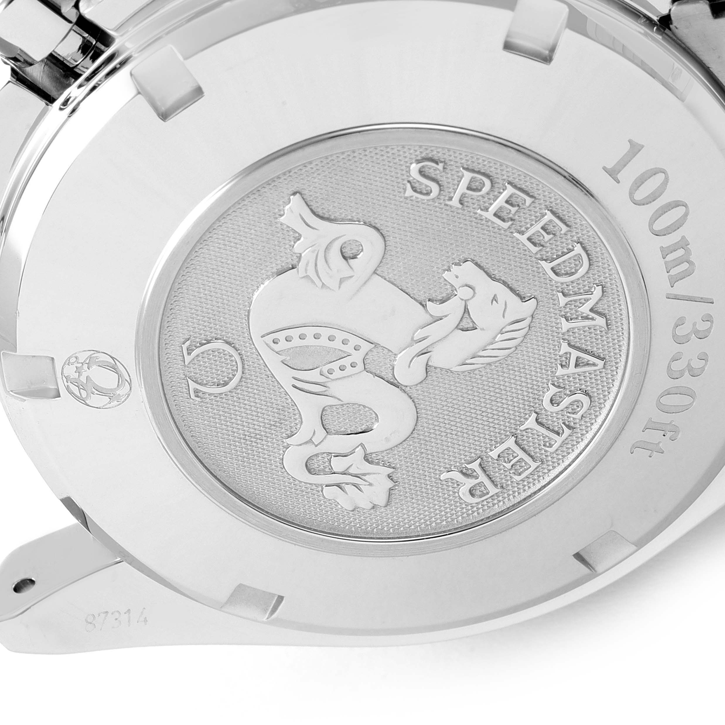 The image shows the back casing of an Omega Speedmaster 323.30.40.40.06.001 Men's Stainless Steel Grey Dial 323.30.40.40.06.001 Men's Stainless Steel Grey Dial watch, featuring an engraved emblem and water resistance marking.