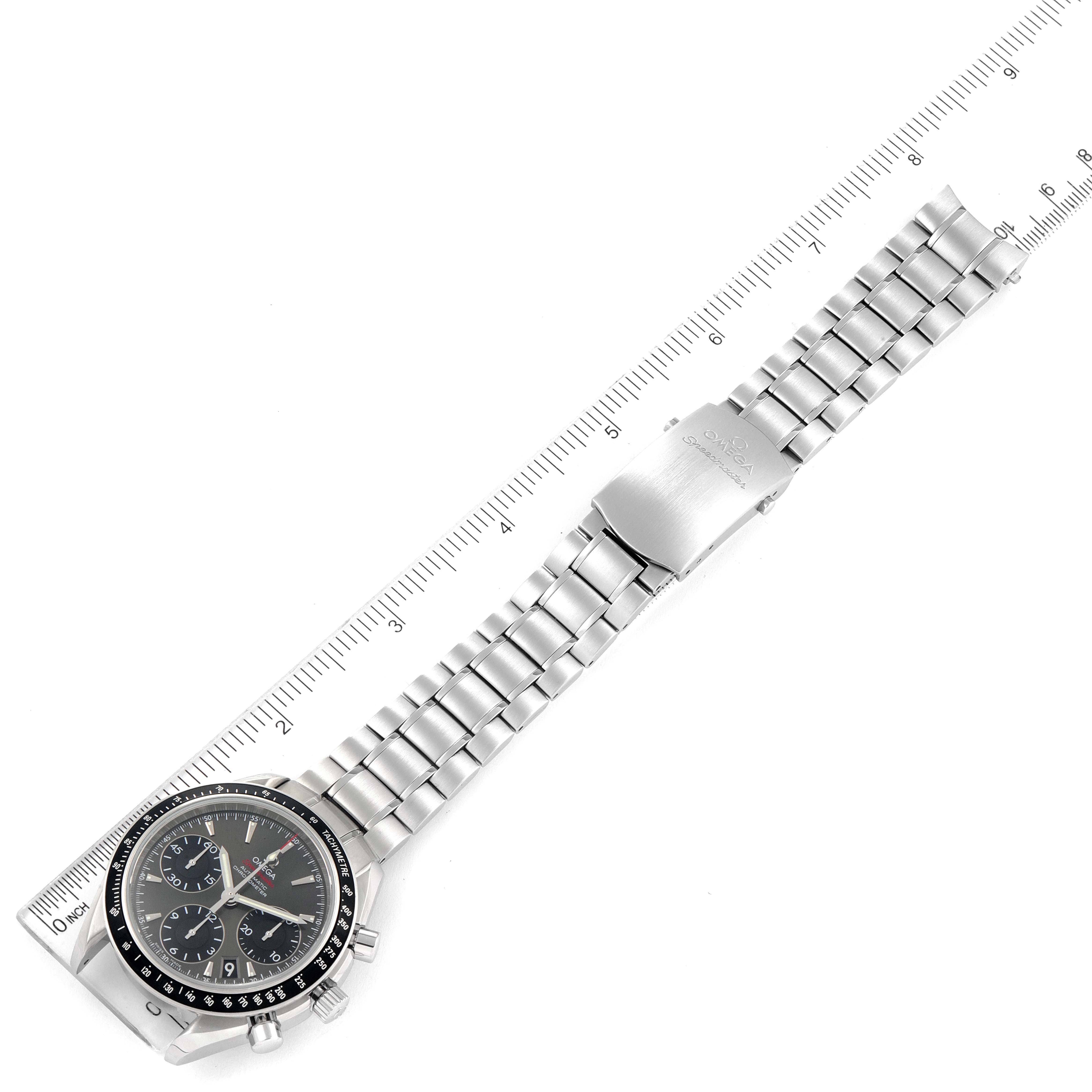 The image shows an Omega Speedmaster 323.30.40.40.06.001 Men's Stainless Steel Grey Dial 323.30.40.40.06.001 Men's Stainless Steel Grey Dial watch at a top-down angle with a ruler for scale, displaying the full watch and metallic bracelet.