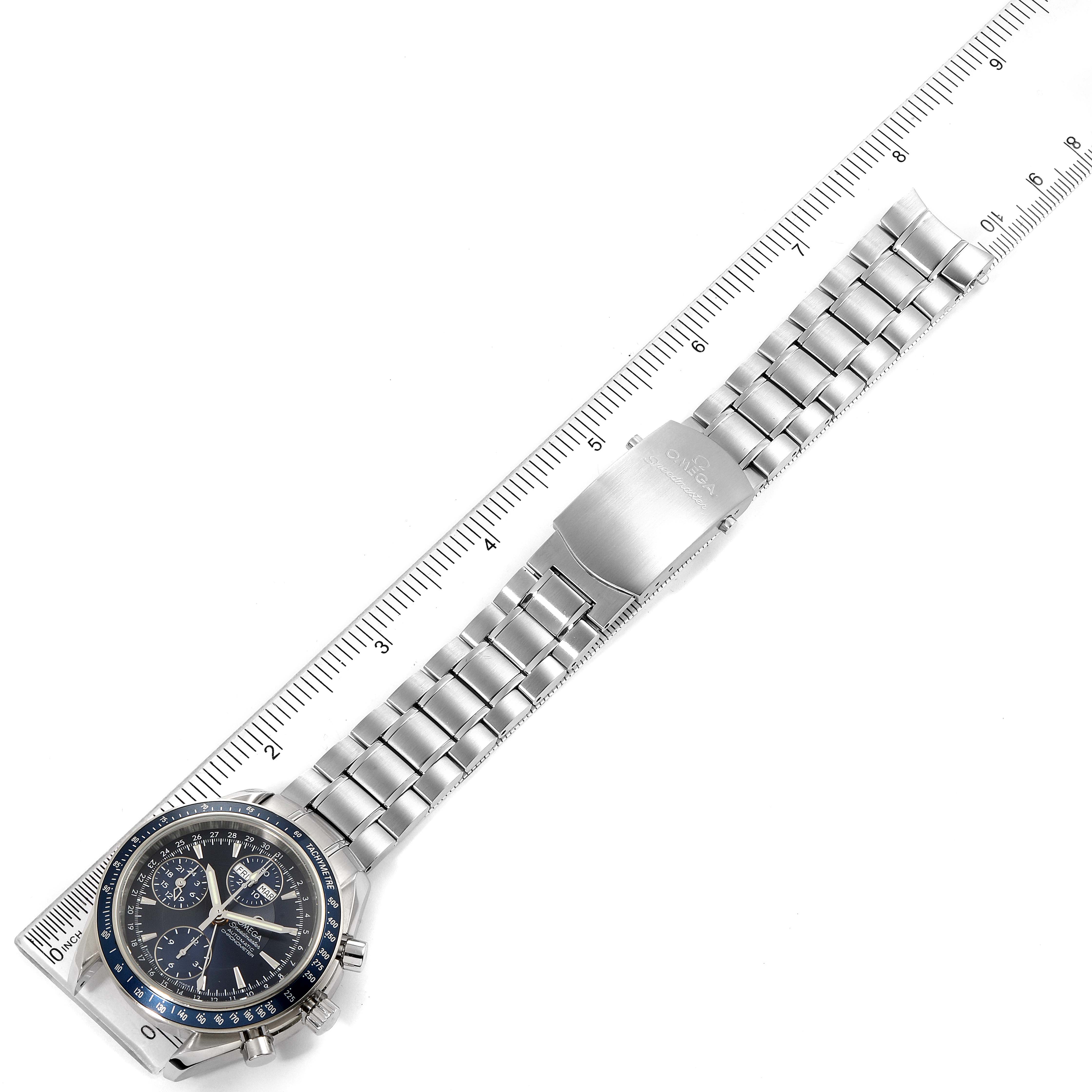 The image shows an Omega Speedmaster 3222.80.00 Men
s Stainless Steel Blue Dial 3222.80.00 Men
s Stainless Steel Blue Dial watch laid flat with a stainless steel bracelet alongside a ruler for scale.