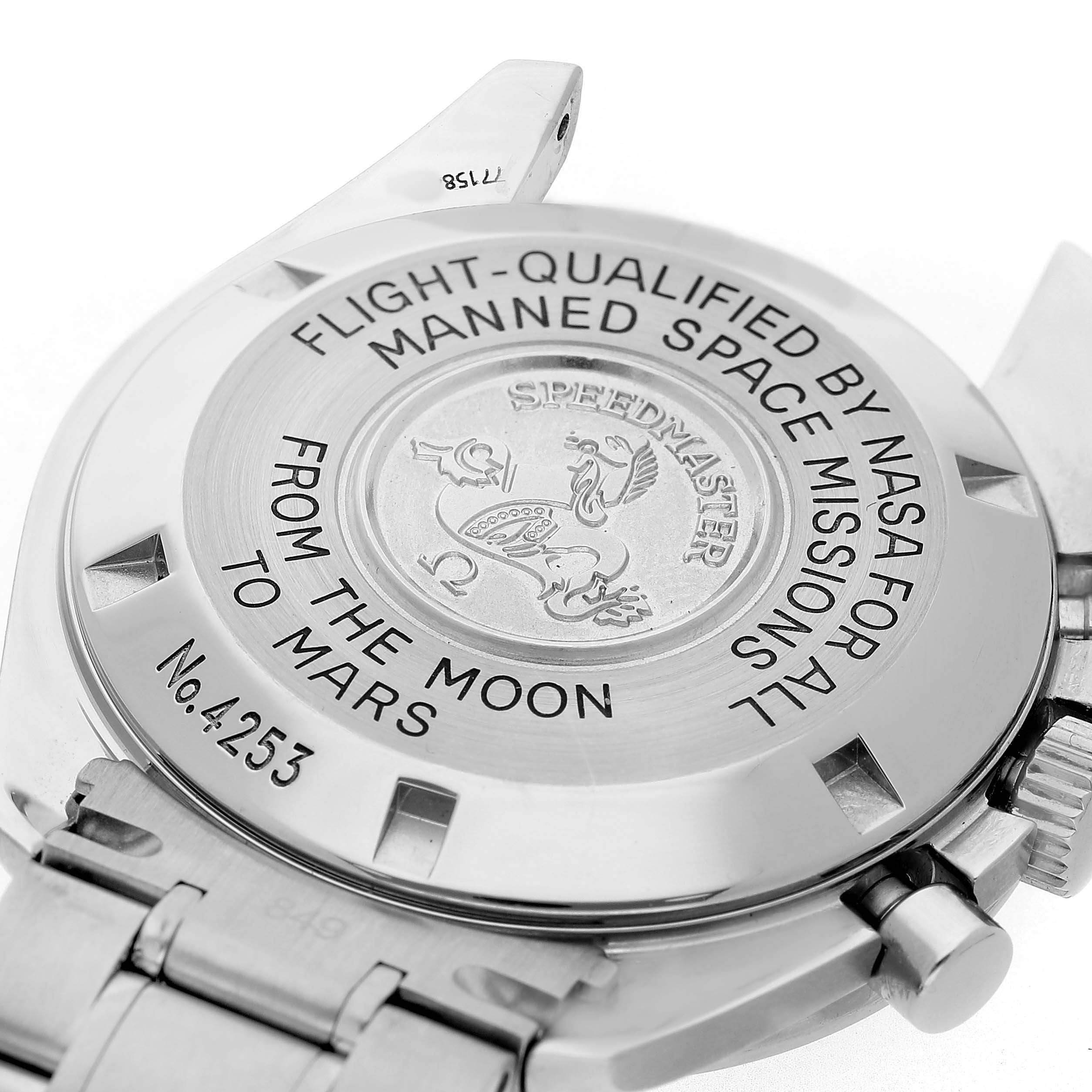 The image shows the back case of an Omega Speedmaster 3577.50.00 Men's Stainless Steel Black Dial, including inscriptions and the bracelet attachment.