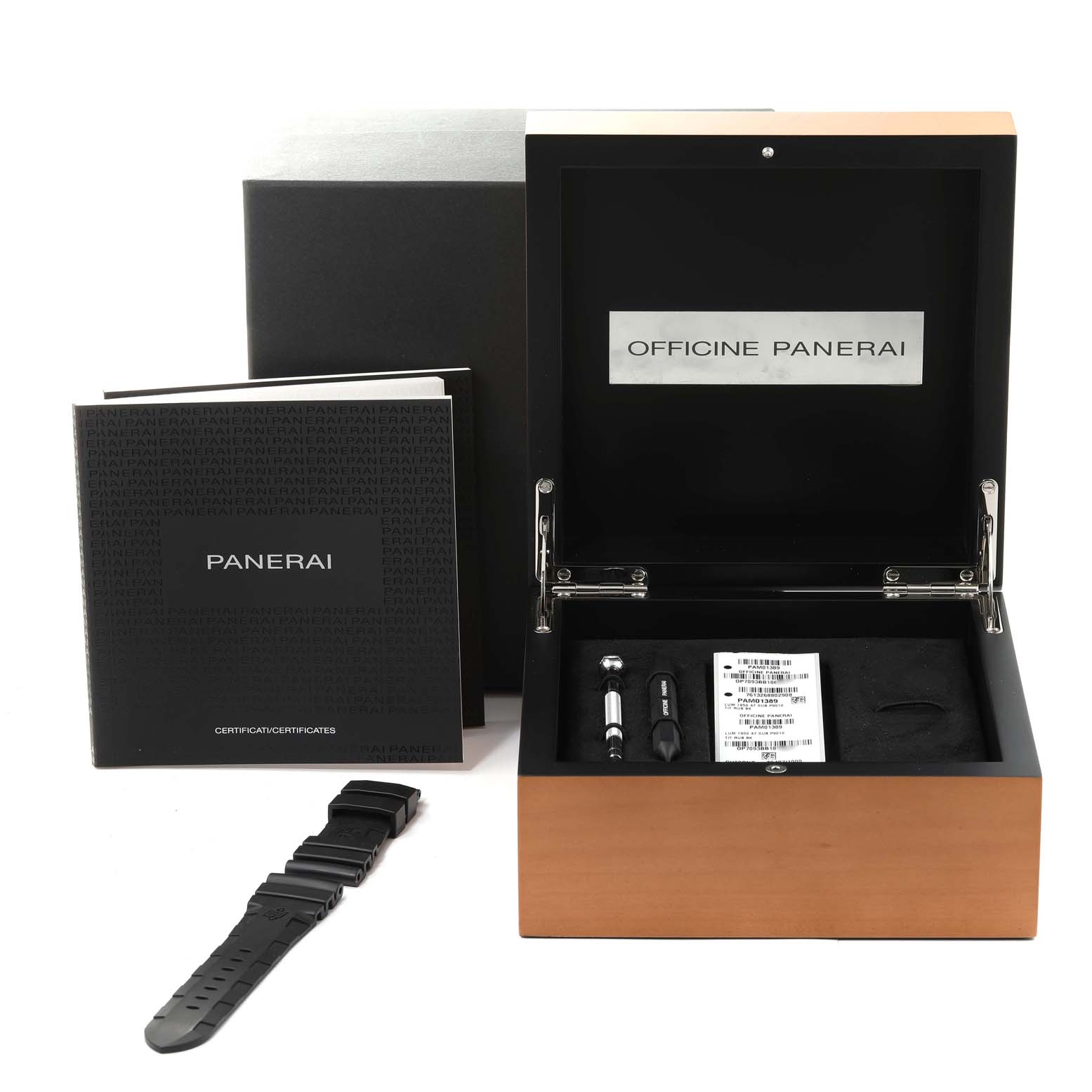 This image shows the packaging, booklet, and accessories of a Panerai Submersible PAM01389 Men
s Titanium Black Dial PAM01389 Men
s Titanium Black Dial watch, including a strap and tools, viewed from the front.