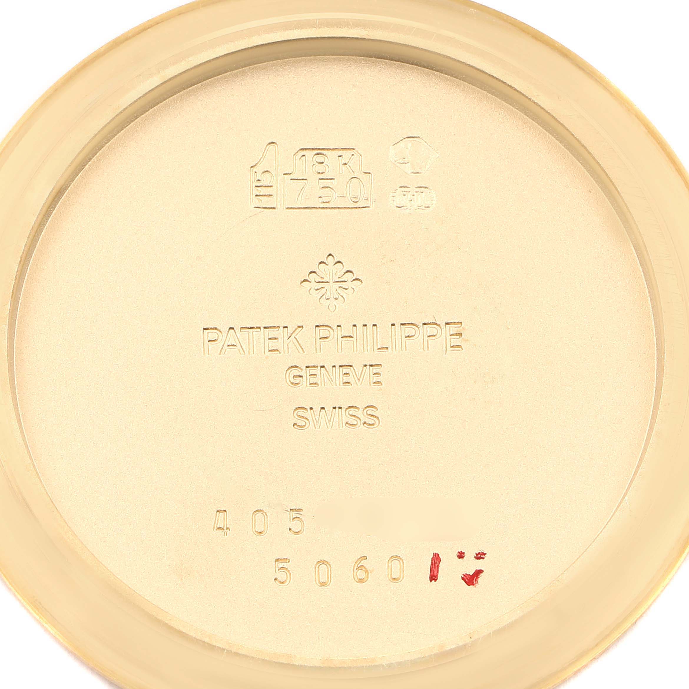 This is an image of the inner case back of a Patek Philippe Aquanaut 5060J Men's Yellow Gold Black Dial 5060J Men's Yellow Gold Black Dial watch, showing the brand engraving and gold hallmark.