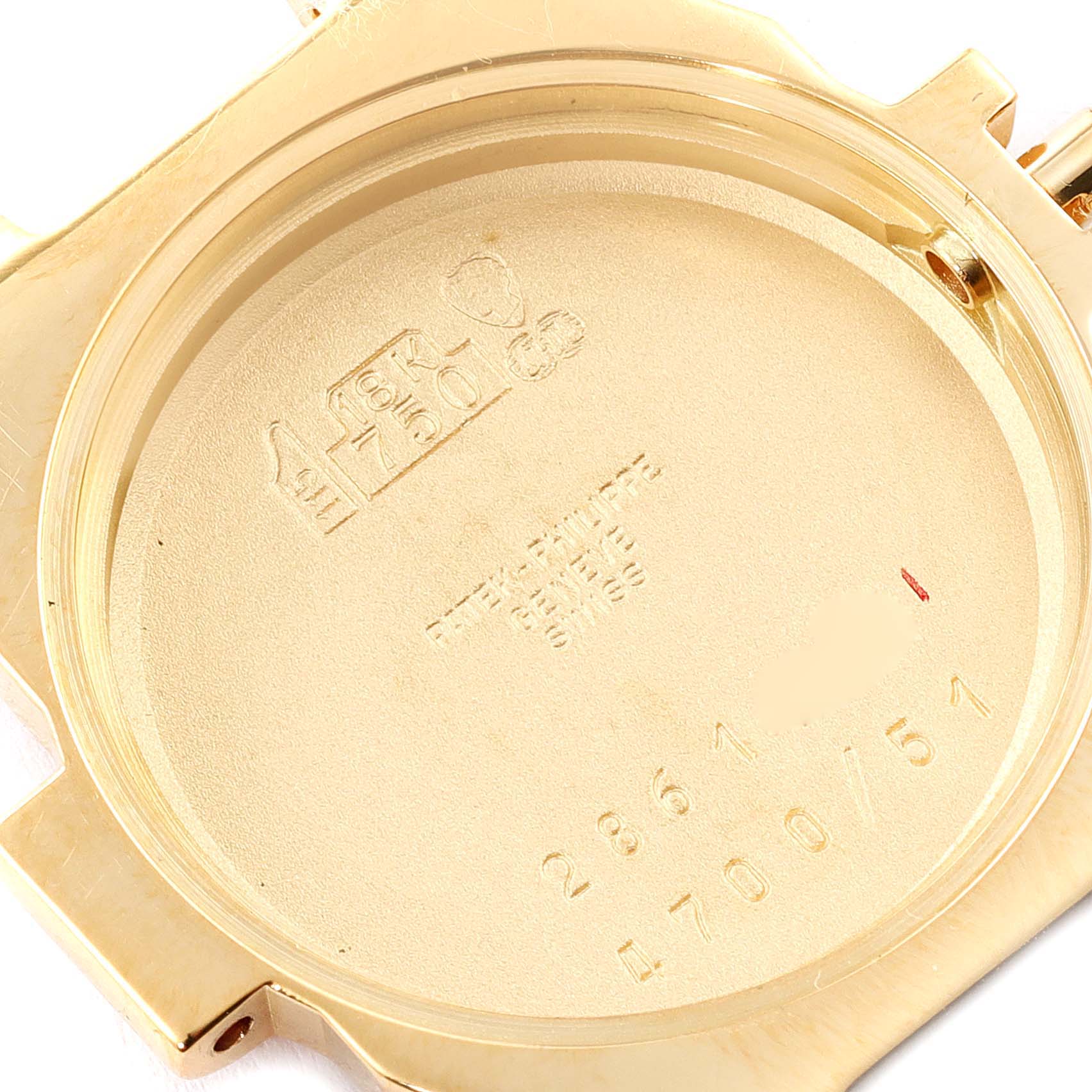 This image shows the interior side of the case back of a Patek Philippe Nautilus 4700/51 Women's Yellow Gold White Dial 4700/51 Women's Yellow Gold White Dial watch, highlighting its engravings and markings.