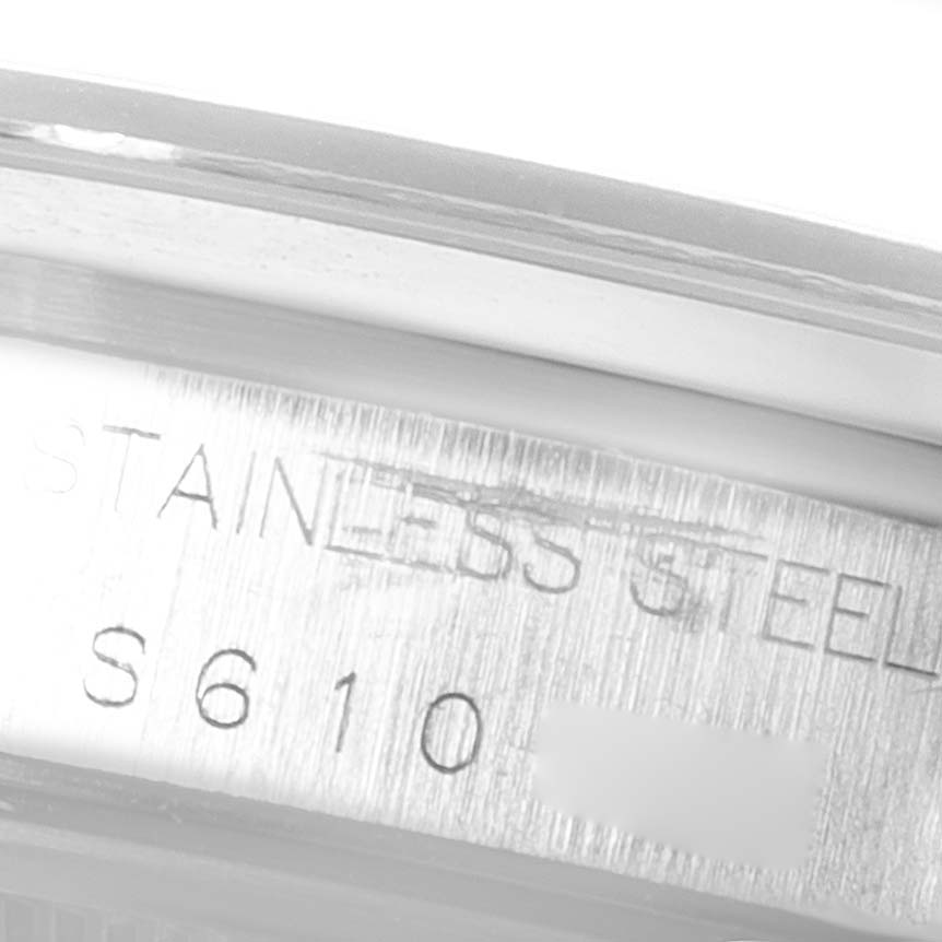 This image shows a close-up of the case engraving on a Rolex Date 15200 Men's Stainless Steel Silver Dial 15200 Men's Stainless Steel Silver Dial model watch, highlighting the "STAINLESS STEEL" text and partial serial number.