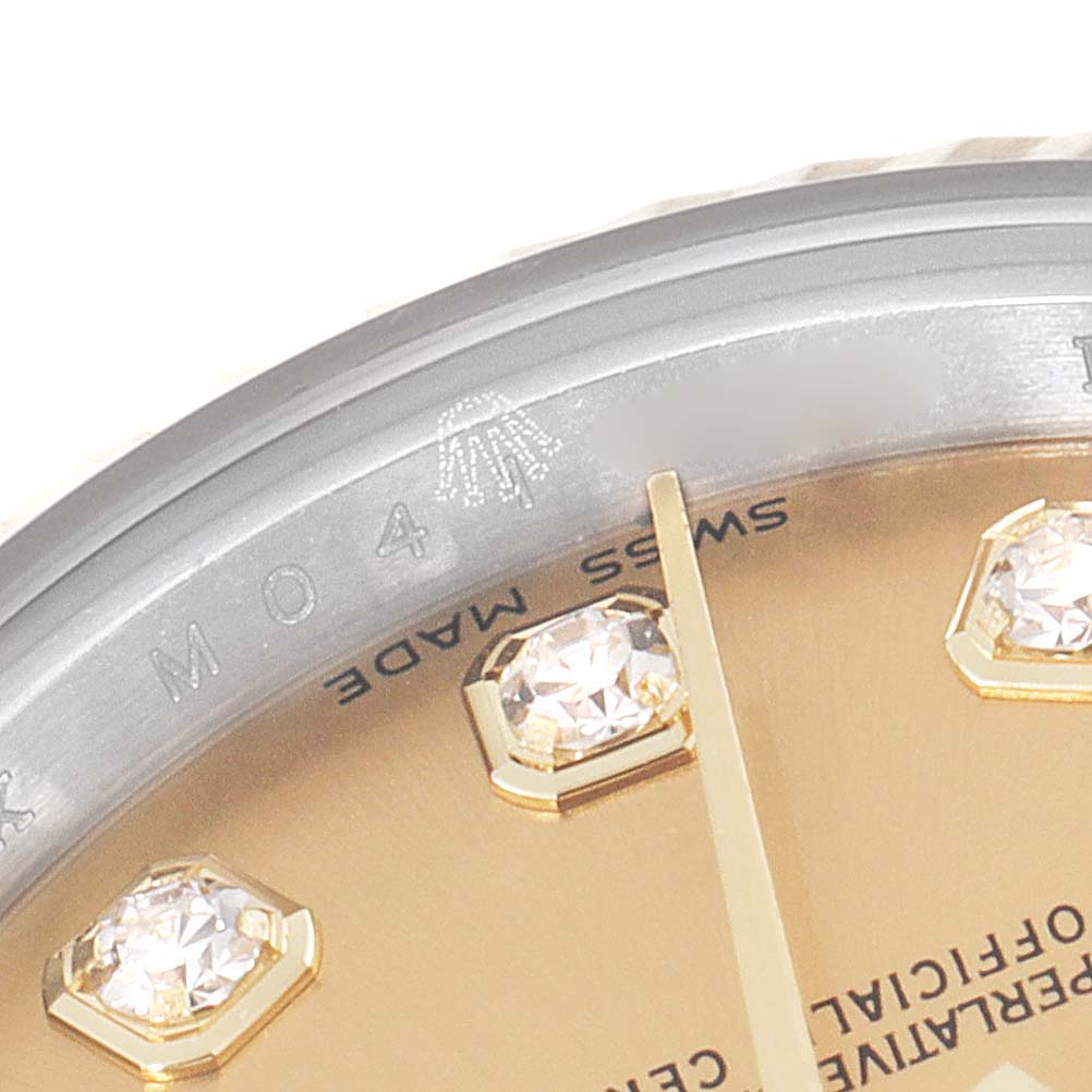 This close-up image shows the dial and diamond hour markers of a Rolex Datejust 179173 Women
s Steel and Gold (two tone) Champagne Dial 179173 Women
s Steel and Gold (two tone) Champagne Dial watch, highlighting the "Swiss Made" text and partial logo.
