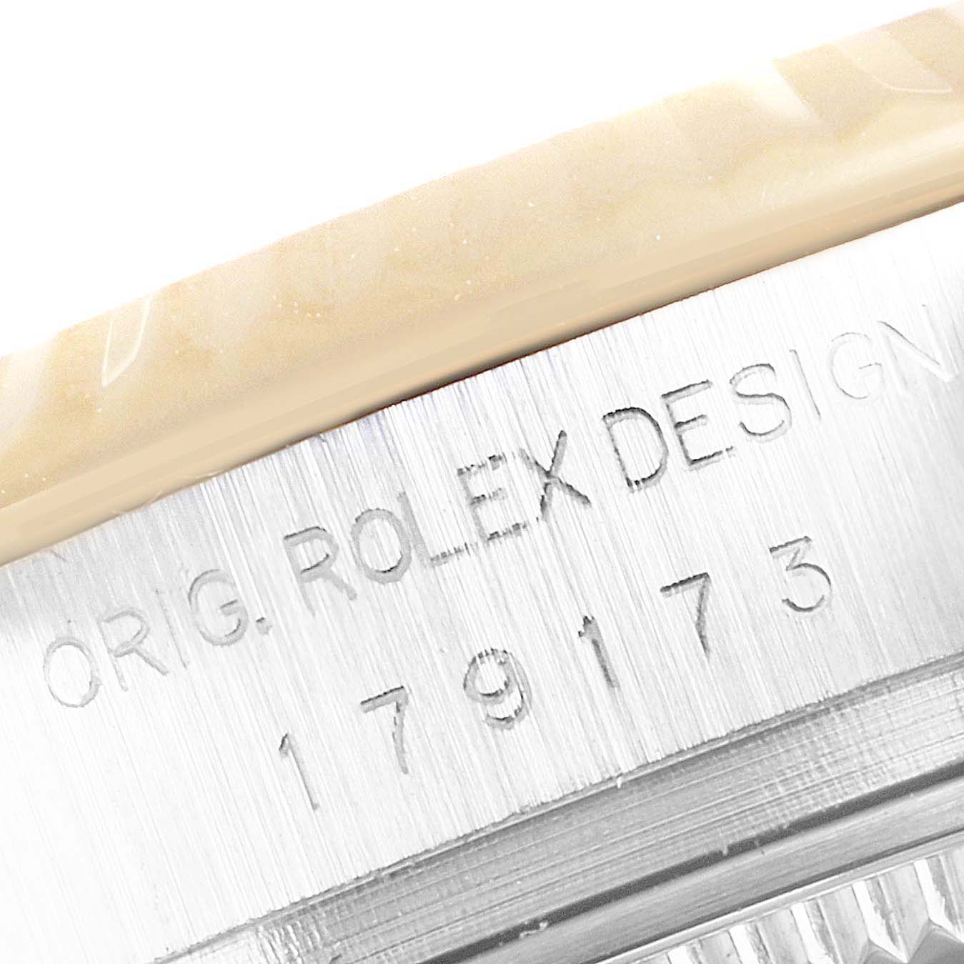 This is a close-up of the side of a Rolex Datejust 179173 Women
s Steel and Gold (two tone) Champagne Dial 179173 Women
s Steel and Gold (two tone) Champagne Dial watch, showing the engraved model information.