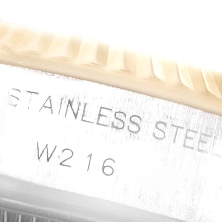 The image shows a close-up angle of the engraved "STAINLESS STEEL" text on the case of the Rolex Datejust 69173 Women
s Steel and Gold (two tone) Champagne Dial 69173 Women
s Steel and Gold (two tone) Champagne Dial watch.