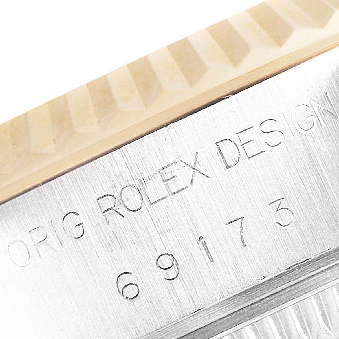 This image shows a close-up of the bezel and case edge of a Rolex Datejust 69173 Women
s Steel and Gold (two tone) Champagne Dial 69173 Women
s Steel and Gold (two tone) Champagne Dial watch, focusing on the engraved model details.
