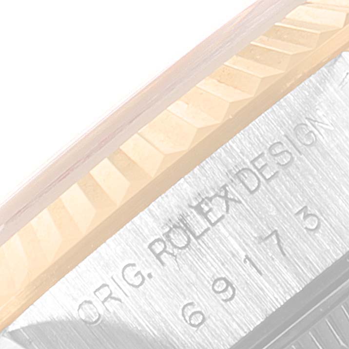 This image shows the detailed engraving and bezel of a Rolex Datejust 69173 Women's Steel and Gold (two tone) Blue Dial 69173 Women's Steel and Gold (two tone) Blue Dial watch.