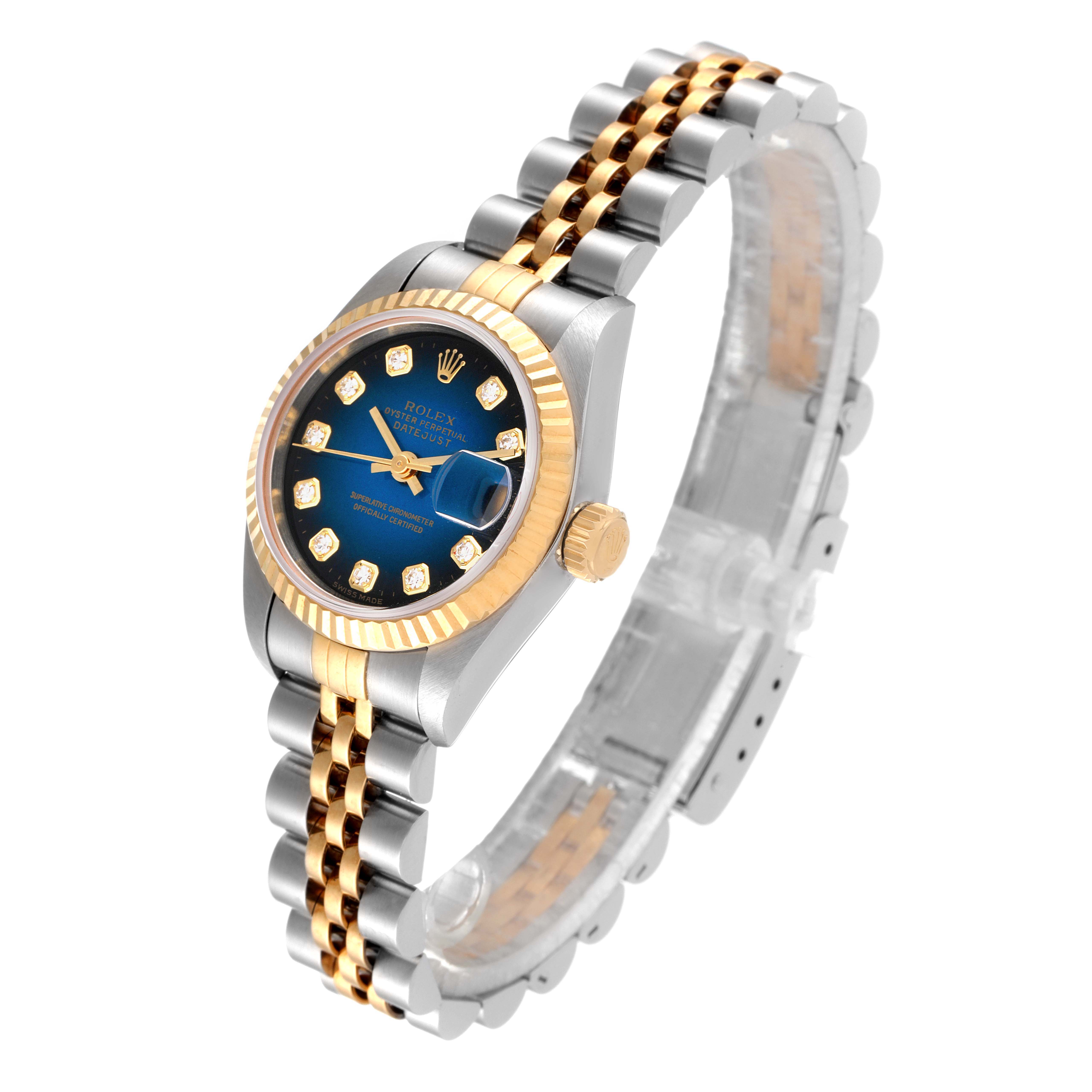 This image shows a Rolex Datejust 69173 Women's Steel and Gold (two tone) Blue Dial 69173 Women's Steel and Gold (two tone) Blue Dial watch from an angled profile, highlighting its two-tone bracelet, blue dial, and fluted bezel.