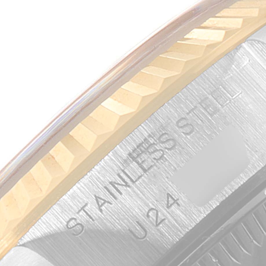 This image shows a close-up of the fluted bezel and part of the stainless steel case back of a Rolex Datejust 69173 Women's Steel and Gold (two tone) Blue Dial 69173 Women's Steel and Gold (two tone) Blue Dial watch.